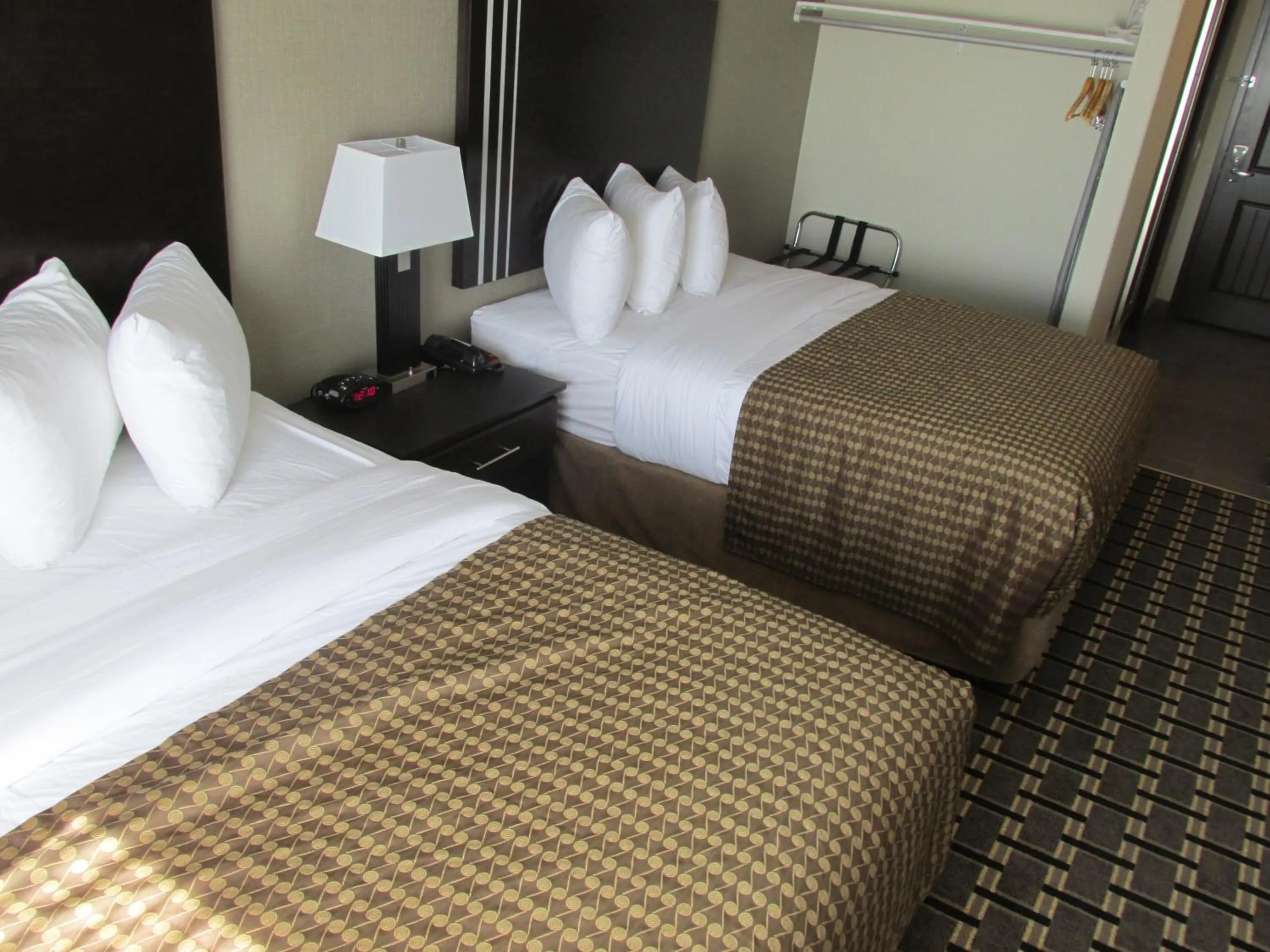 Bed in Sigma Inn & Suites