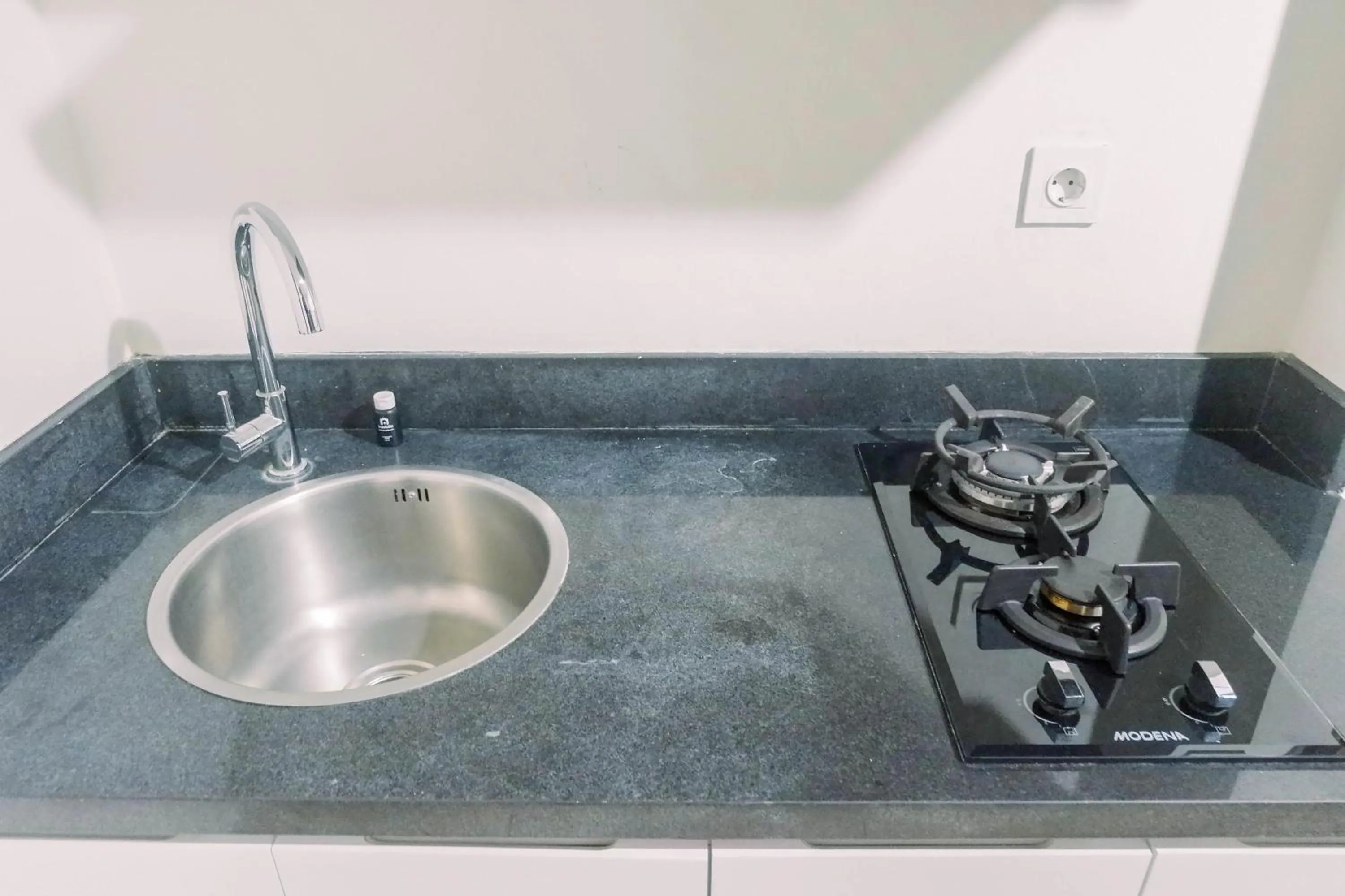 Kitchen or kitchenette in Lavish 2BR Apartment at Grand Sungkono Lagoon By Travelio