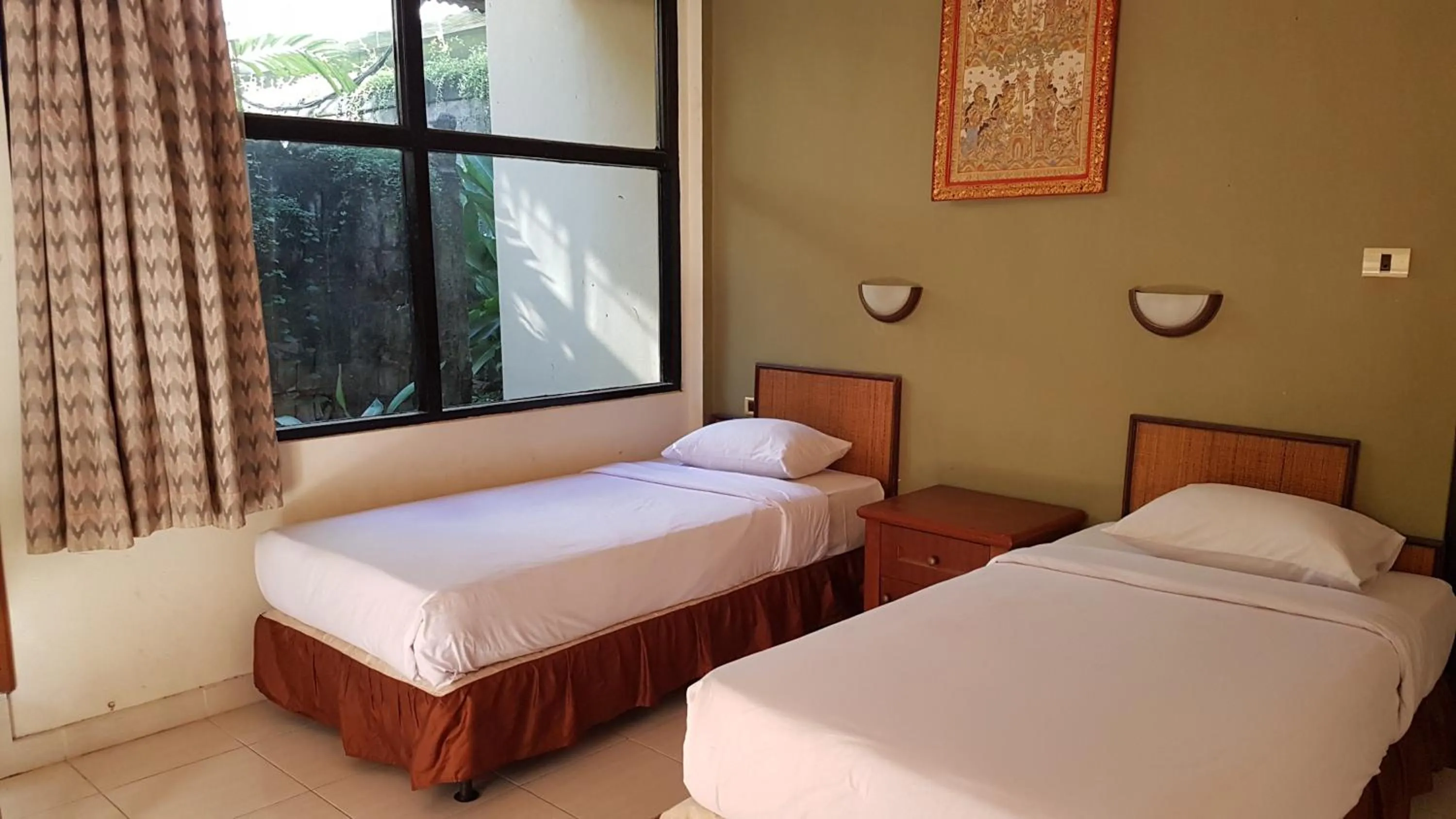 Bed in Troppo Zone Puri Rama Resort Kuta