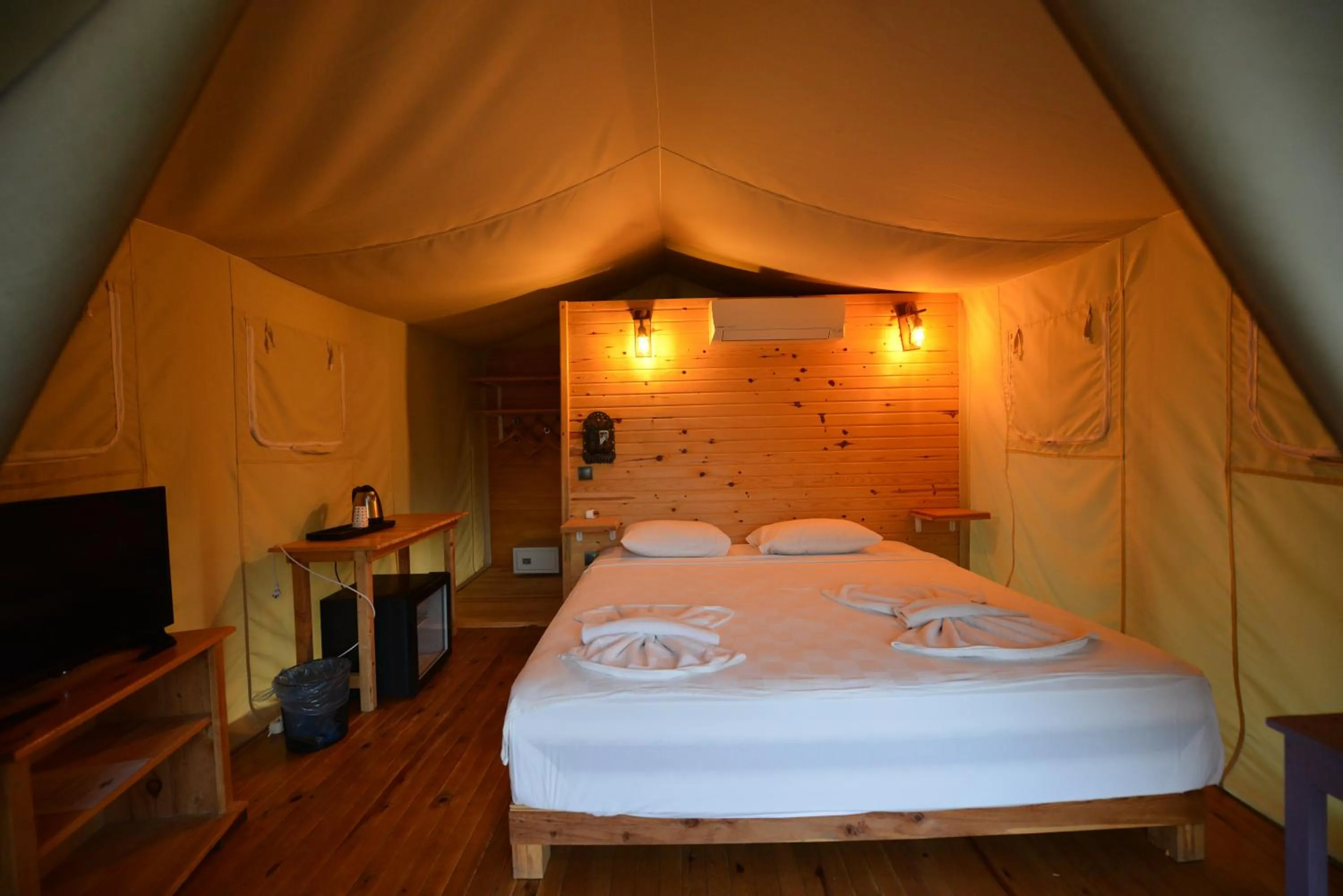 Bed in Green Pine Bungalows & Beach Luxury Concept