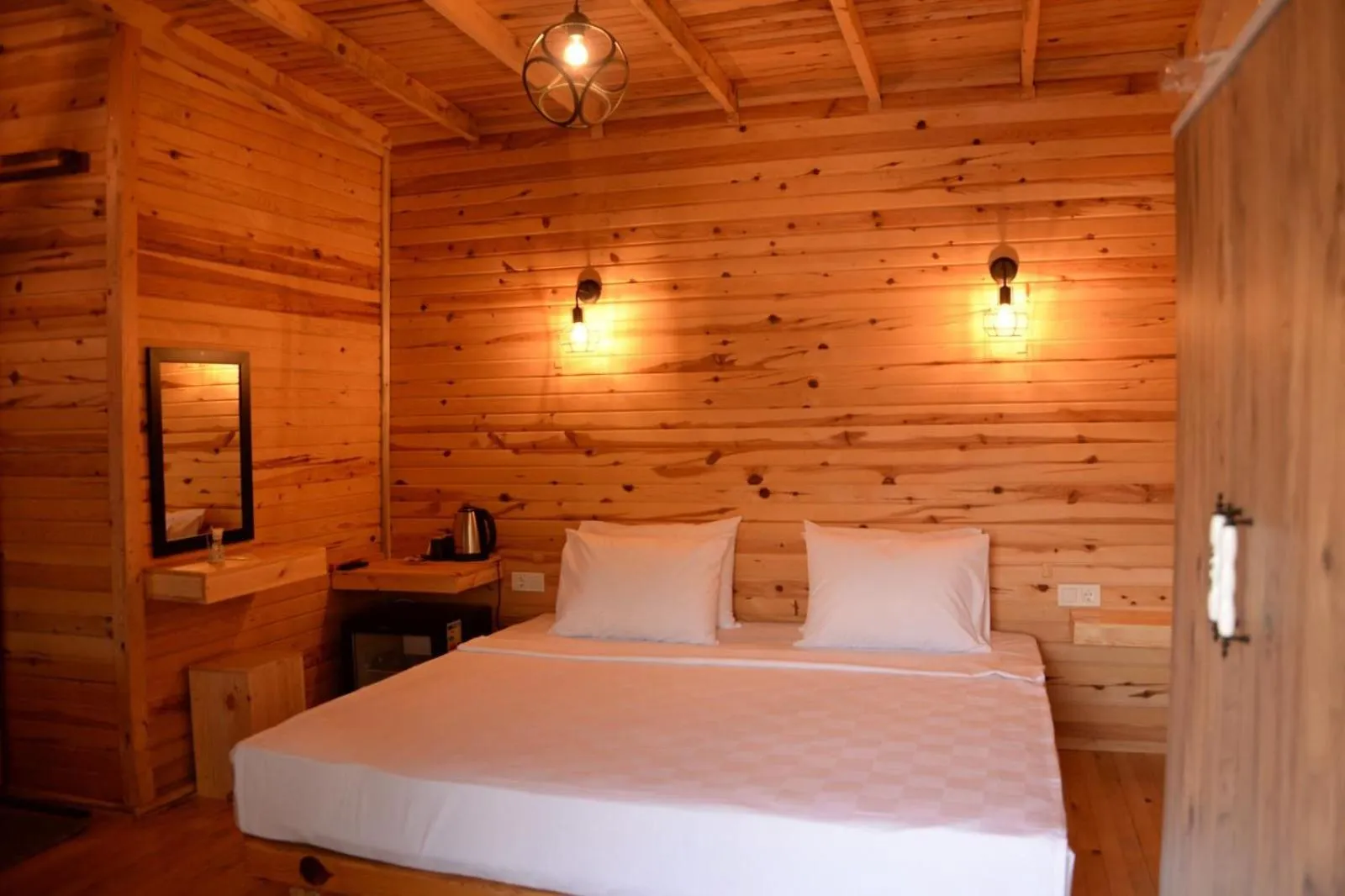 Bed in Green Pine Bungalows & Beach Luxury Concept