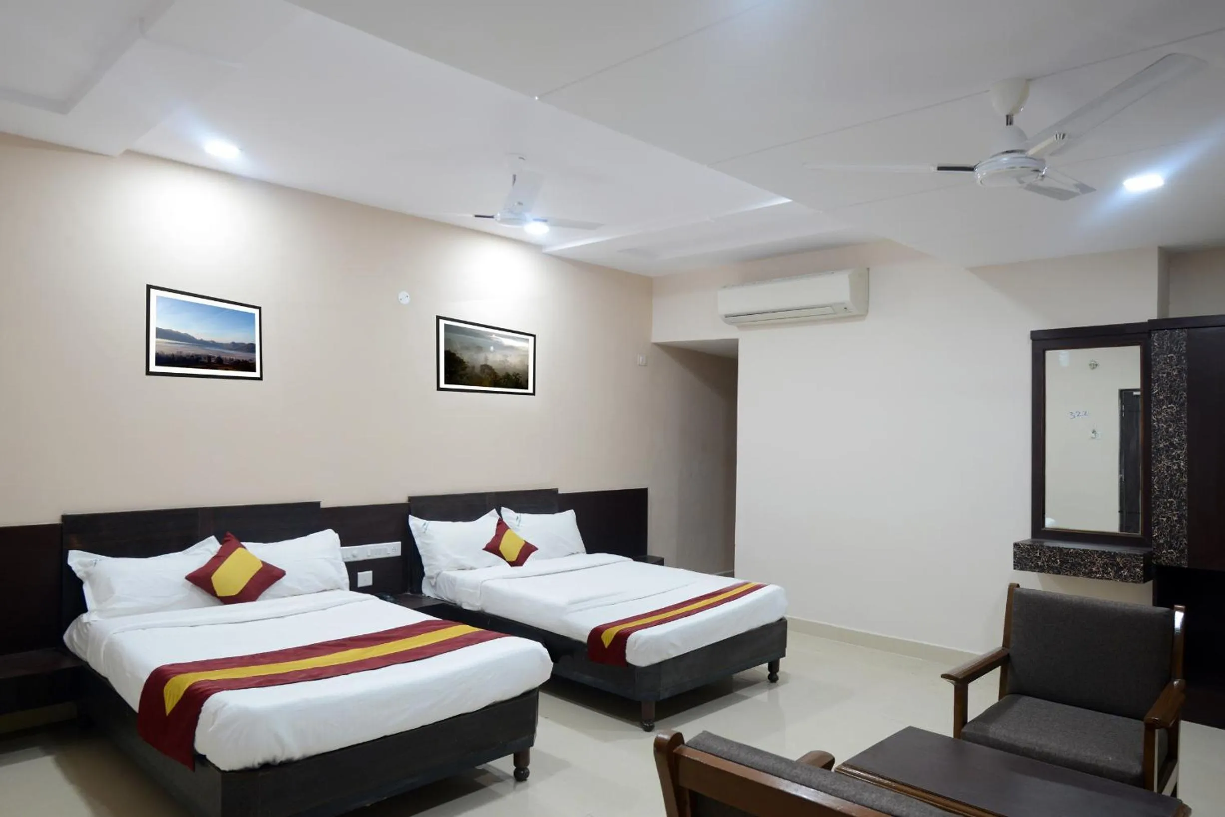 Photo of the whole room, Bed in Dwaraka Inn
