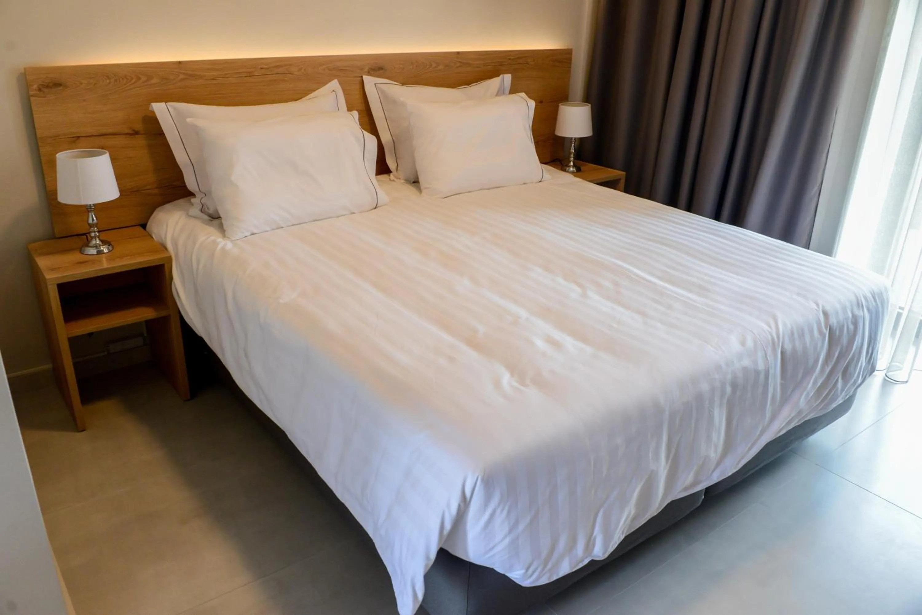 Bed in Comfort Suites & Rooms