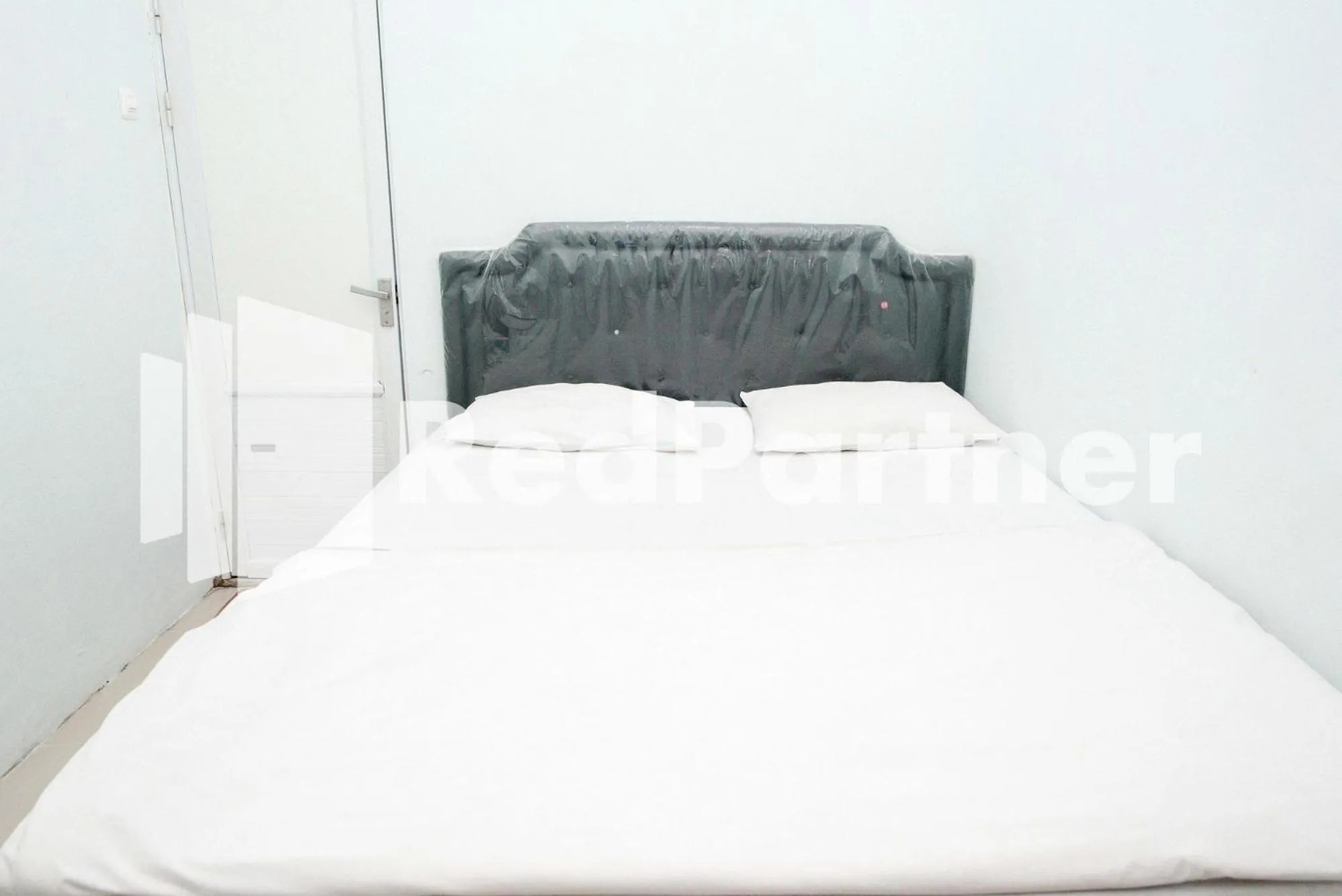 Bed in Happy Inn Puspo Mitra RedDoorz