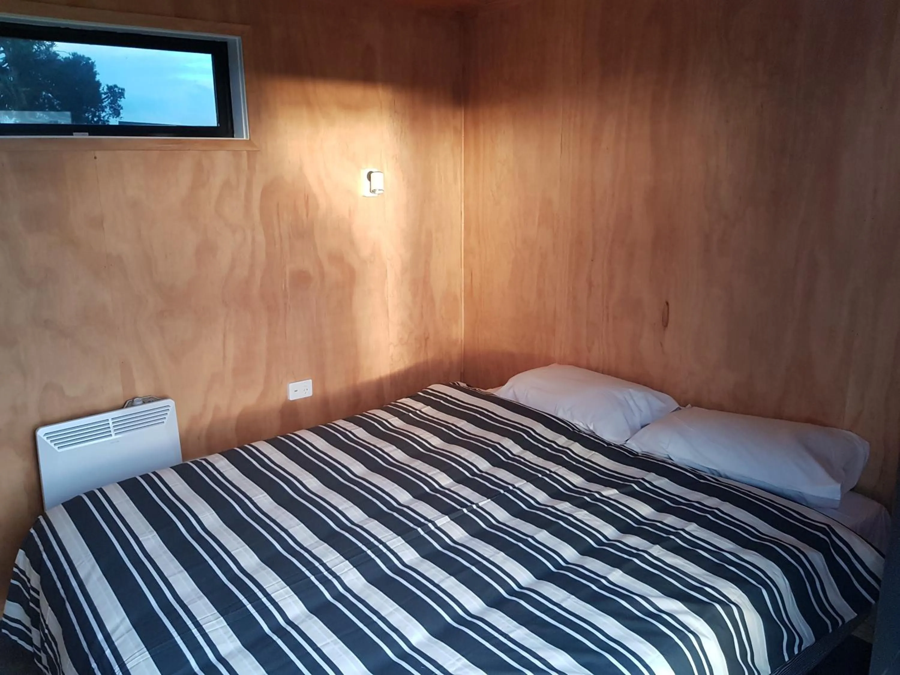 Bed in Waitomo Homestead Cabins