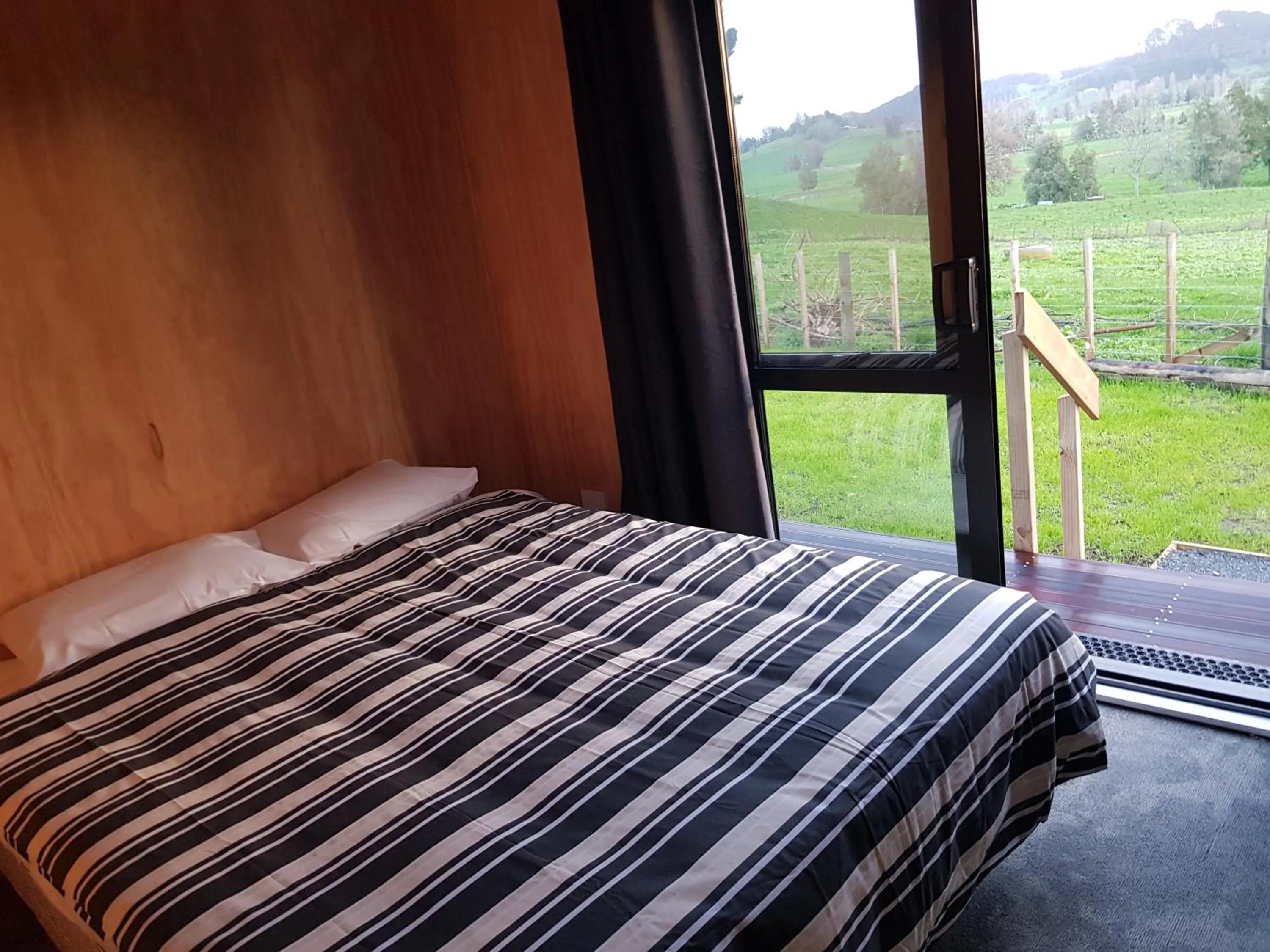 Bed in Waitomo Homestead Cabins