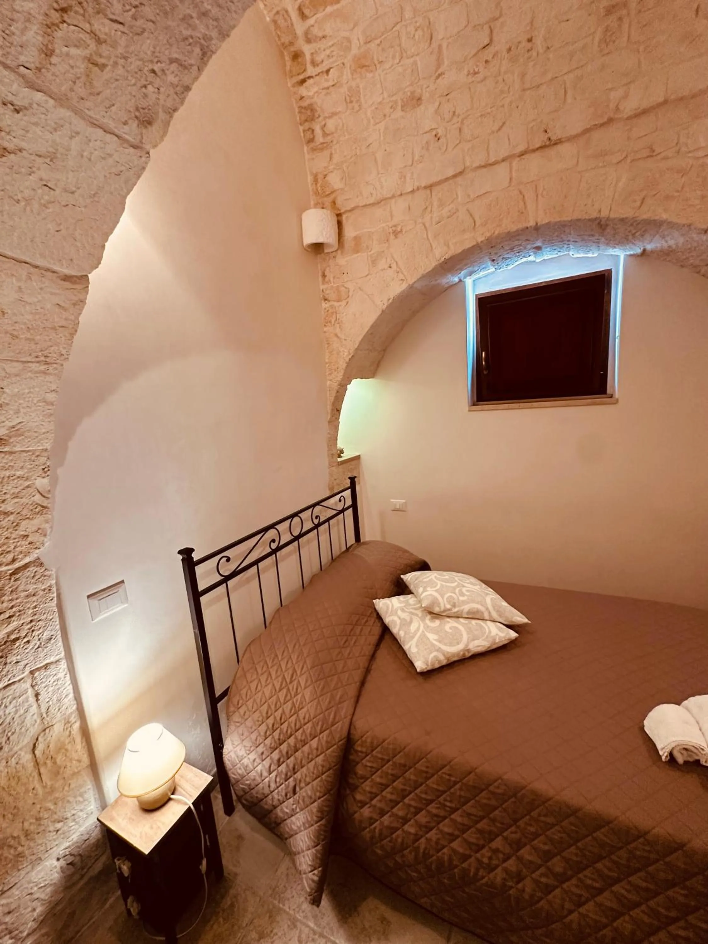 Bed in Pietra Rosa Apulian Home