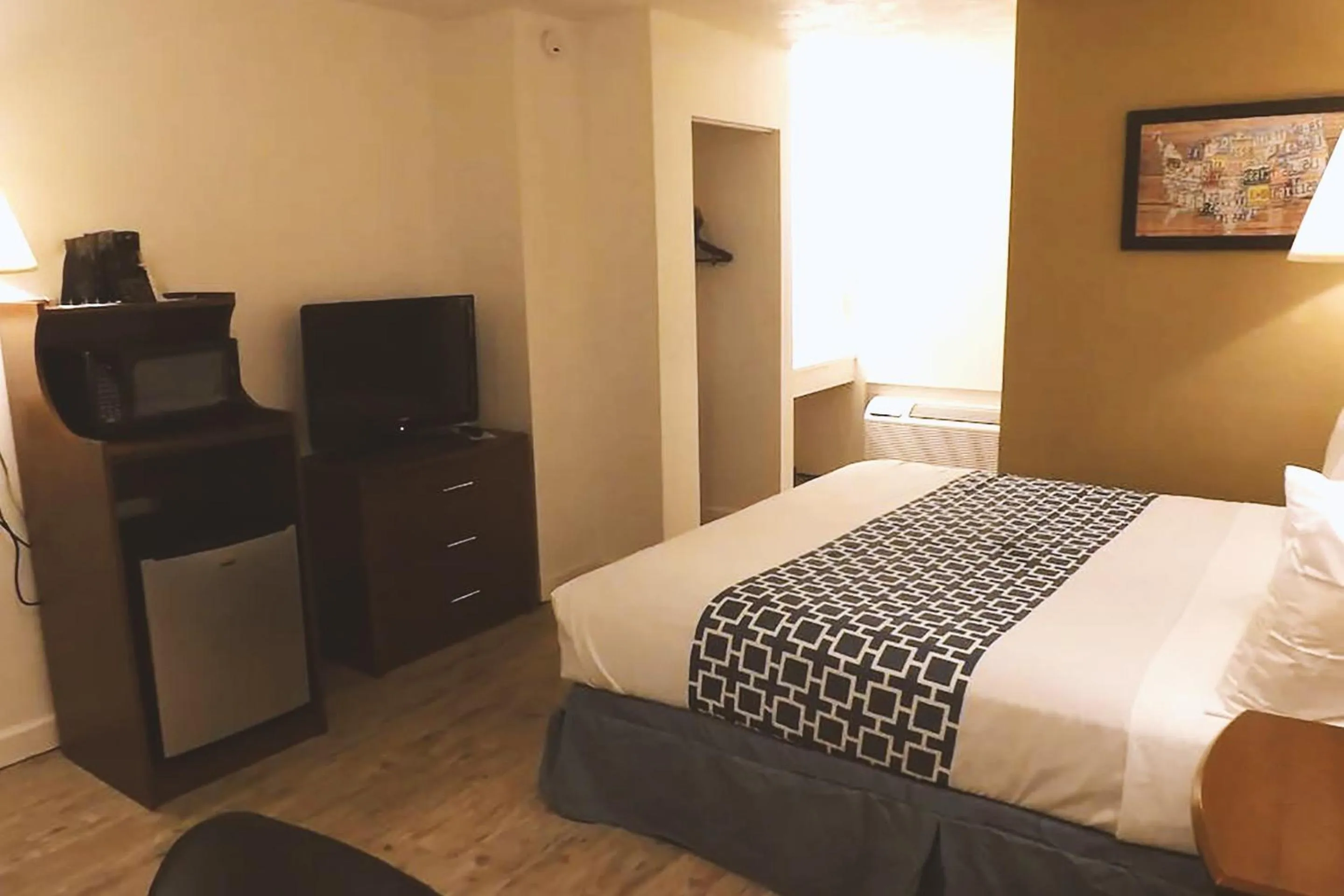 Bed in Coratel Inn & Suites by Jasper McCook