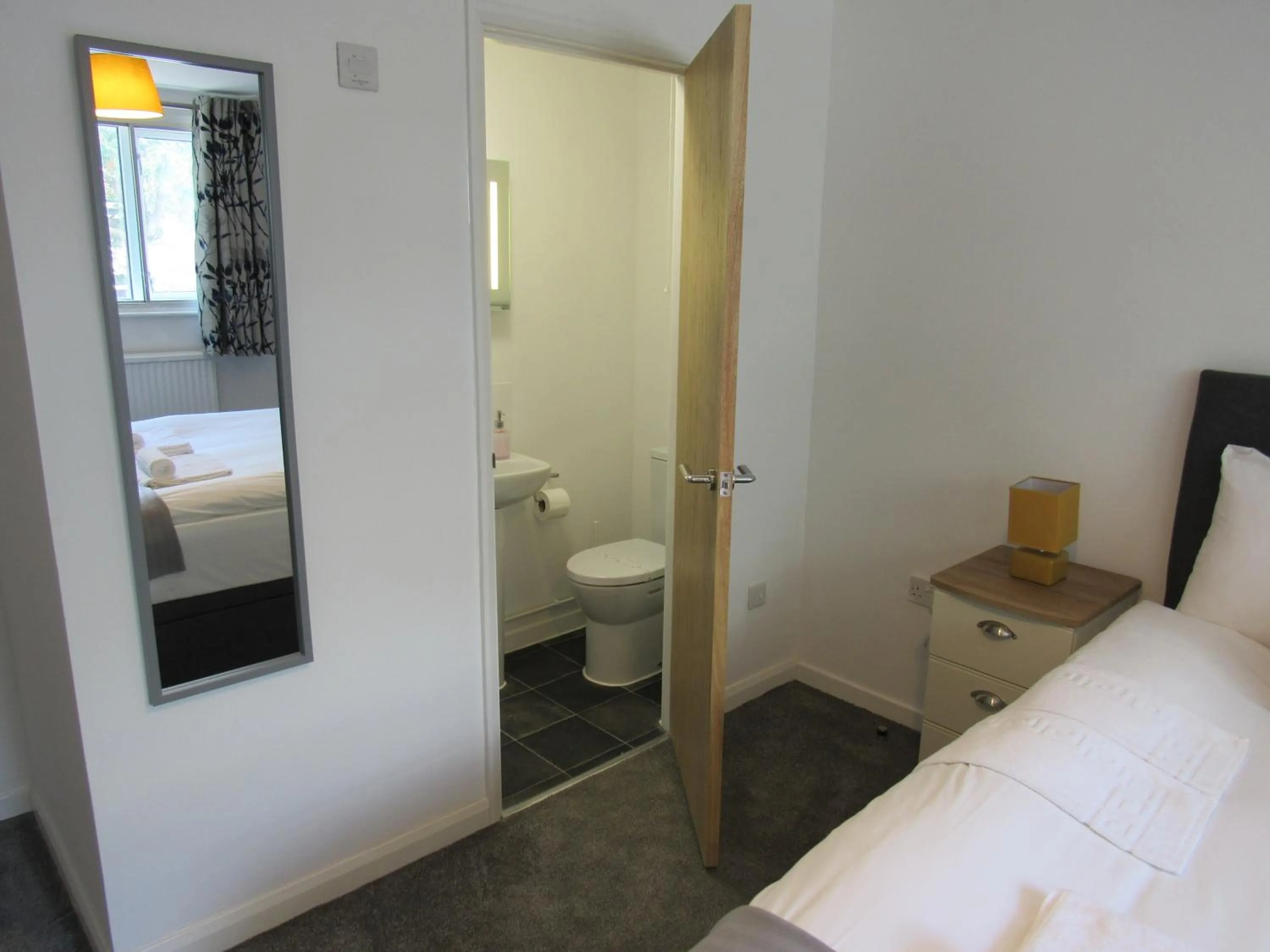 Bed in The Cambridge Suites - Tas Accommodations