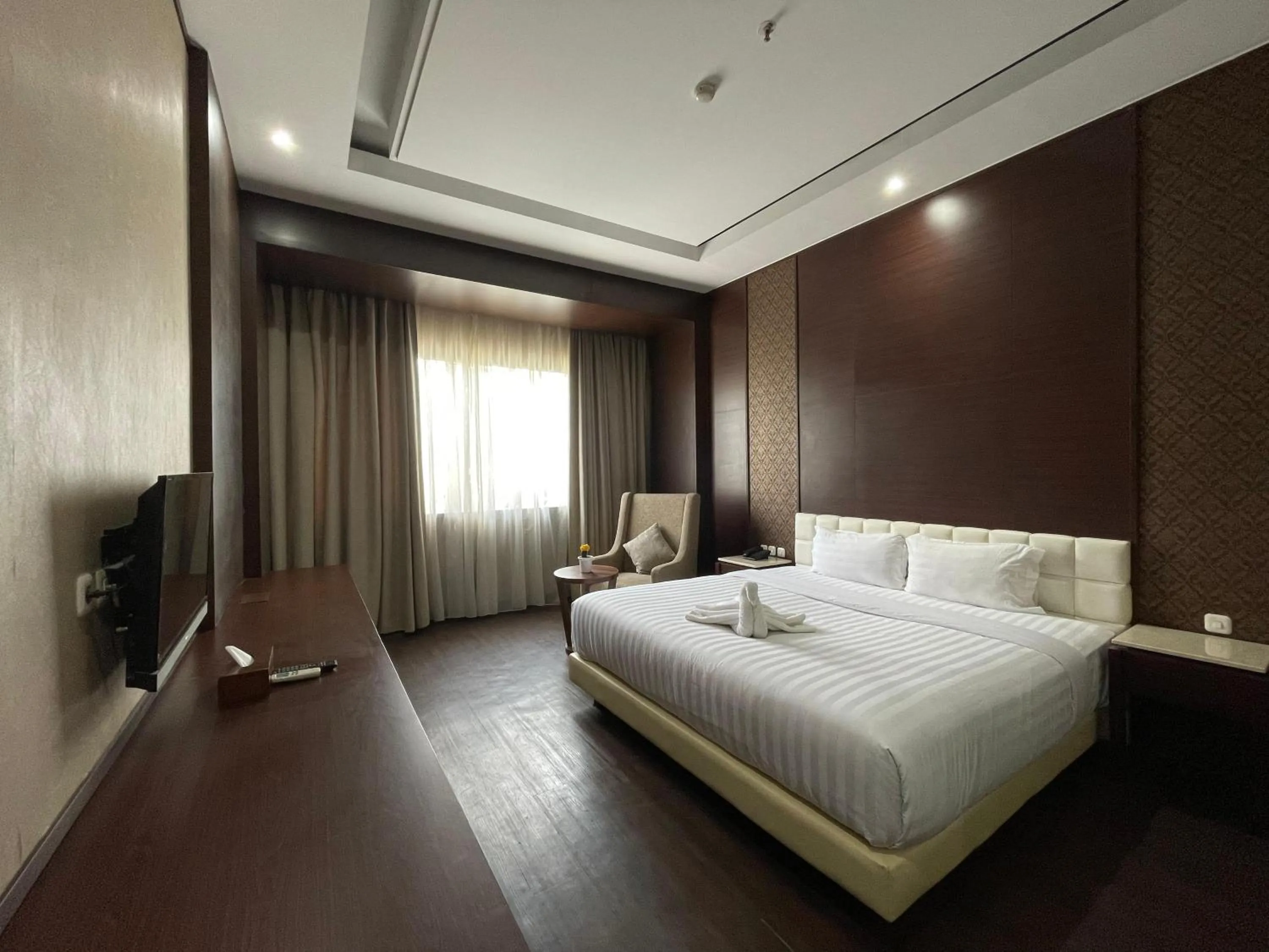 Bed in Grand Arjuna Hotel