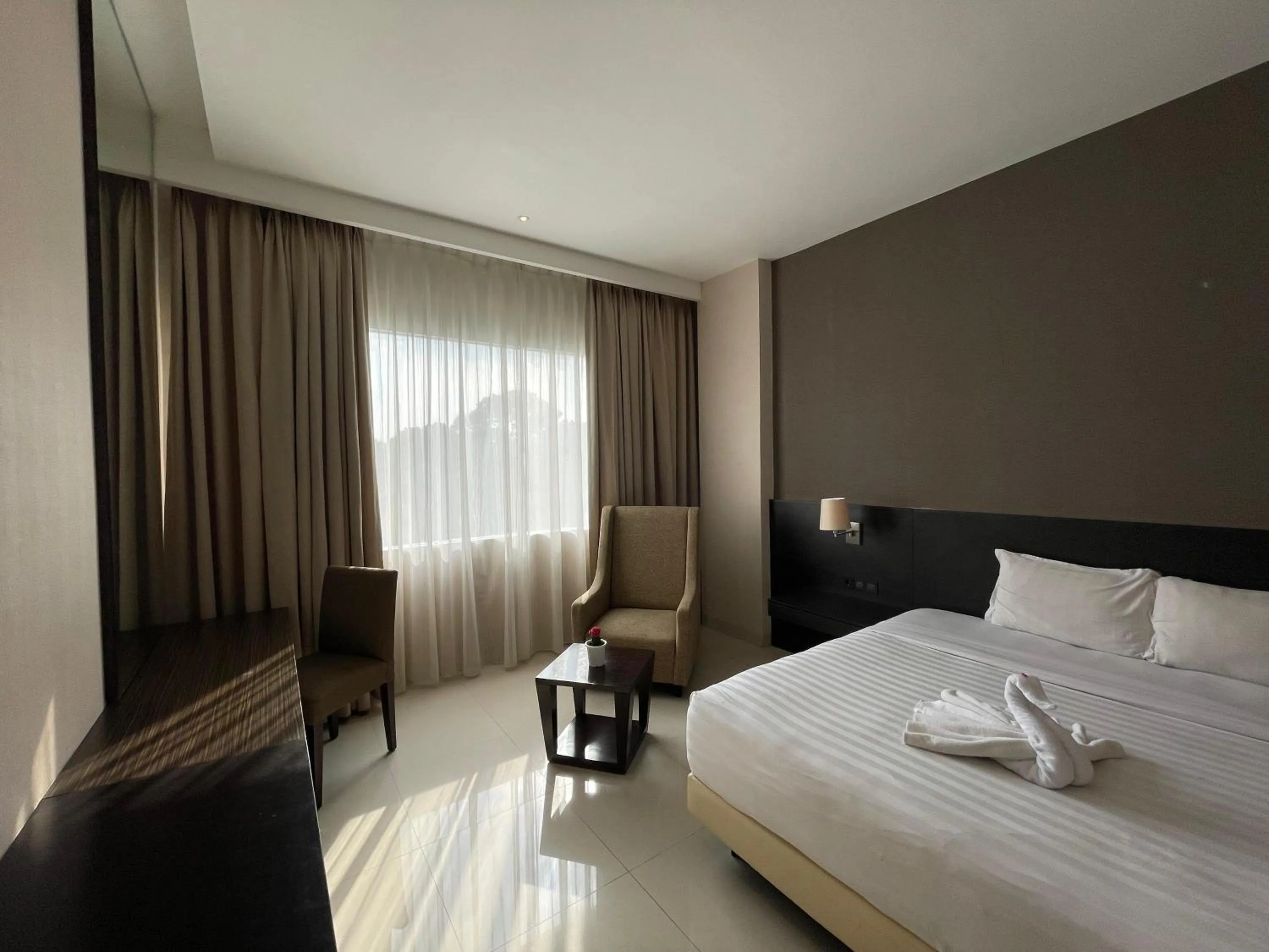 Bed in Grand Arjuna Hotel