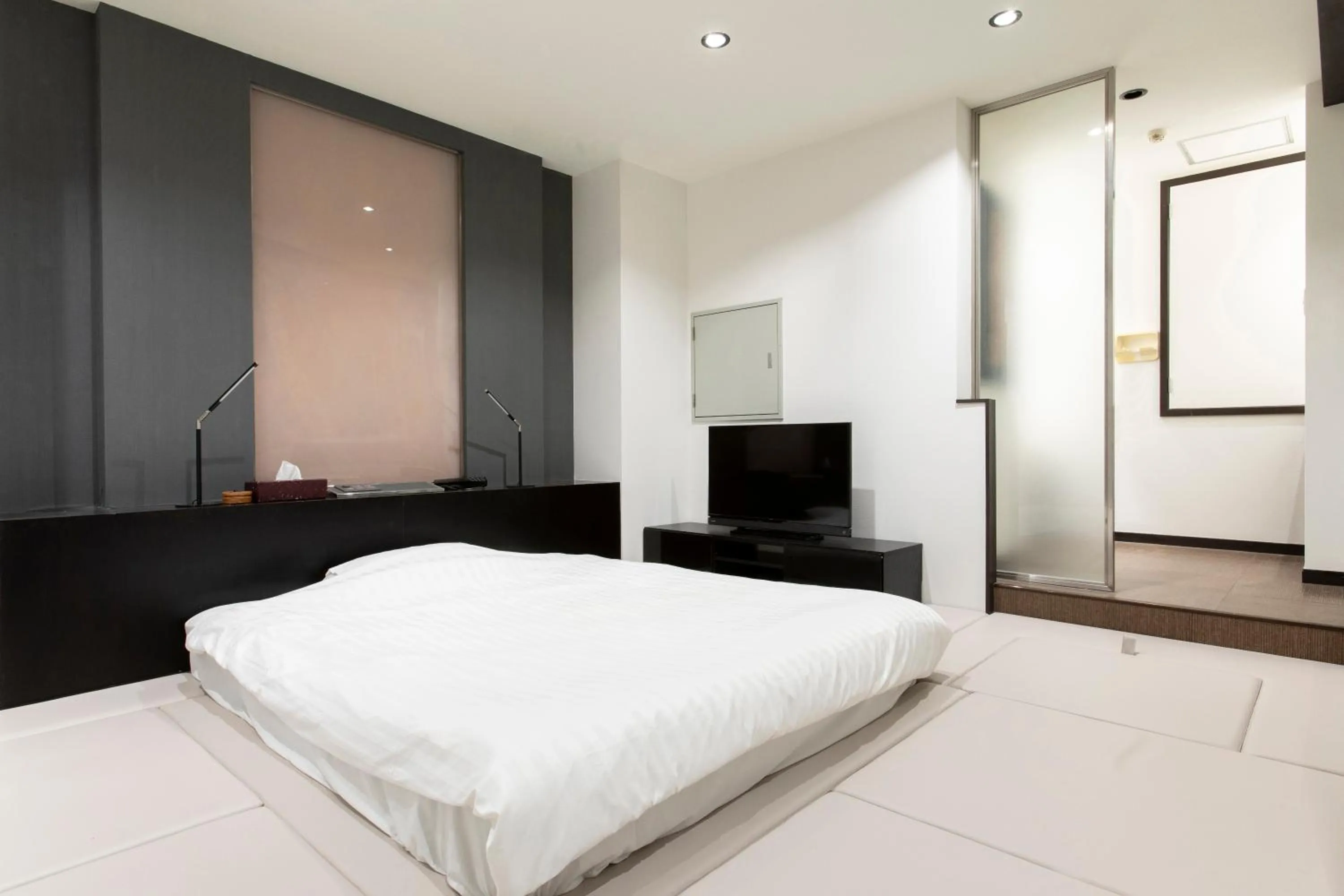 Bed in THE MANGA HOTEL TOGO