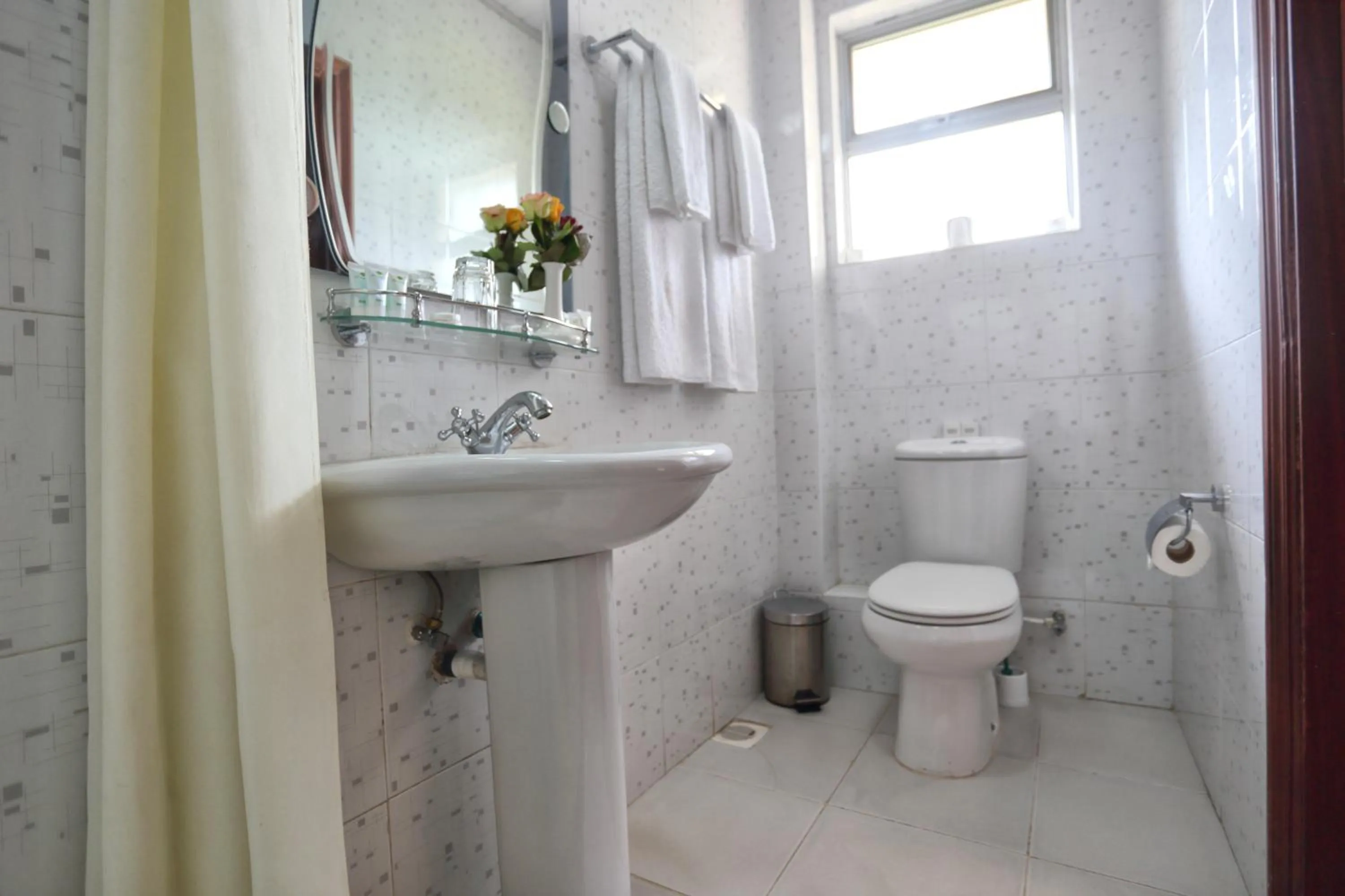 Toilet in Longview Suites Hotel