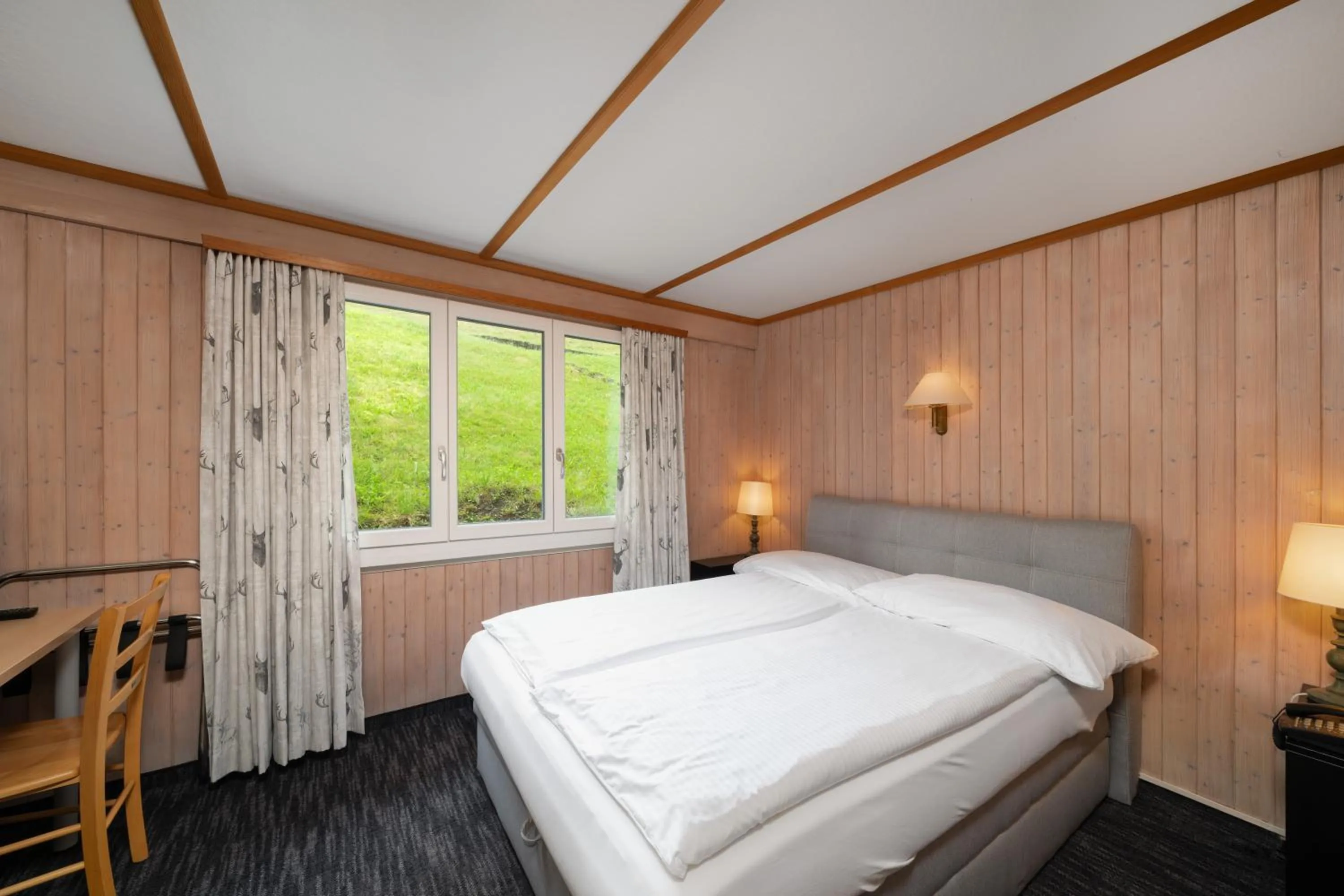 Bed in Jungfrau Lodge, Swiss Mountain Hotel