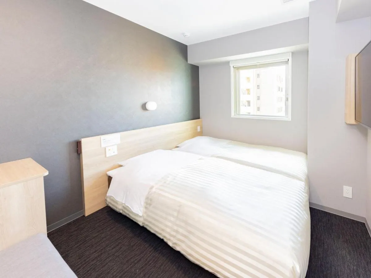 Bed in Super Hotel Sapporo Kitagojo Dori