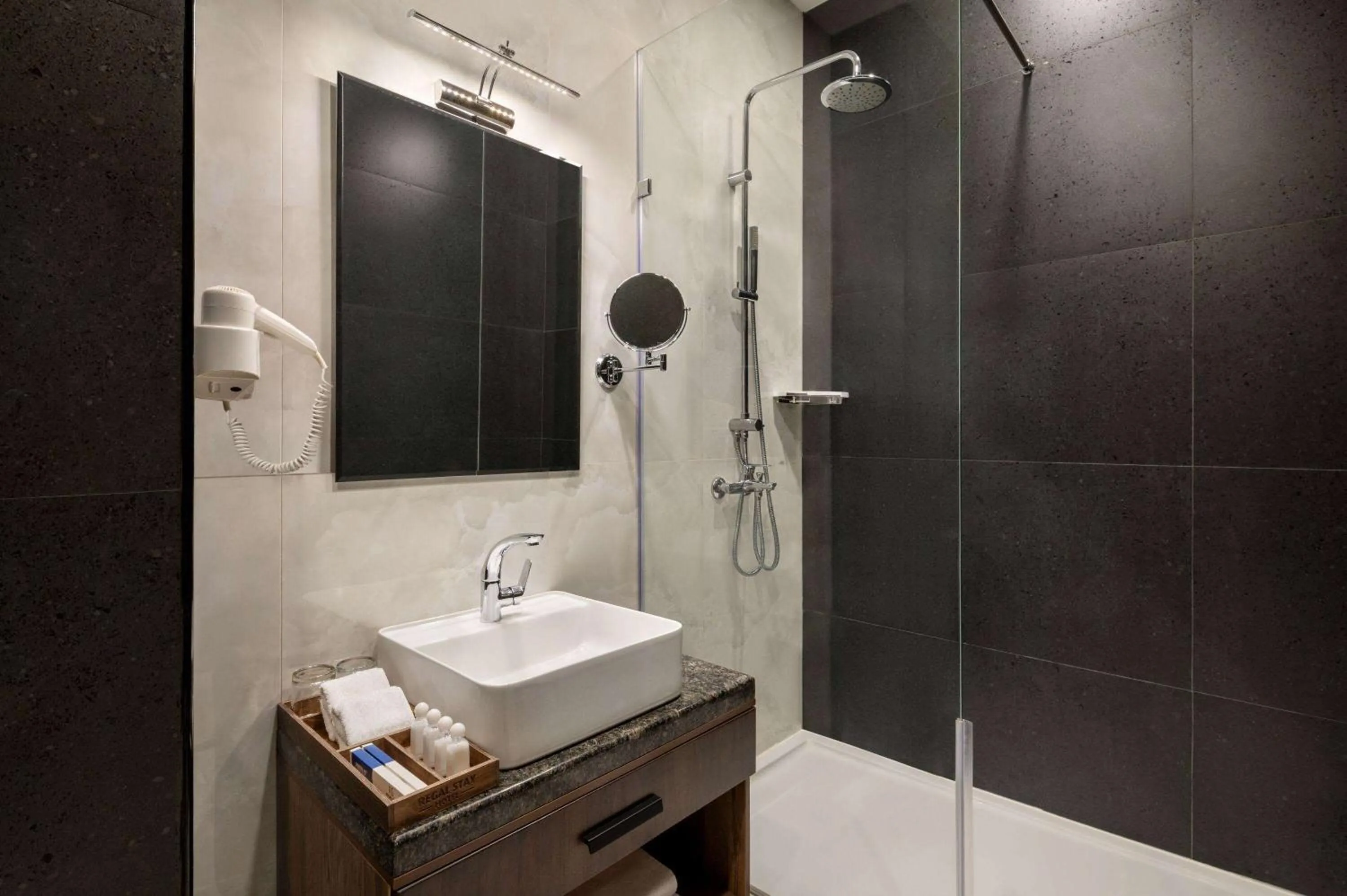 TV and multimedia, Bathroom in Regal Stay Hotel by HotelPro Group