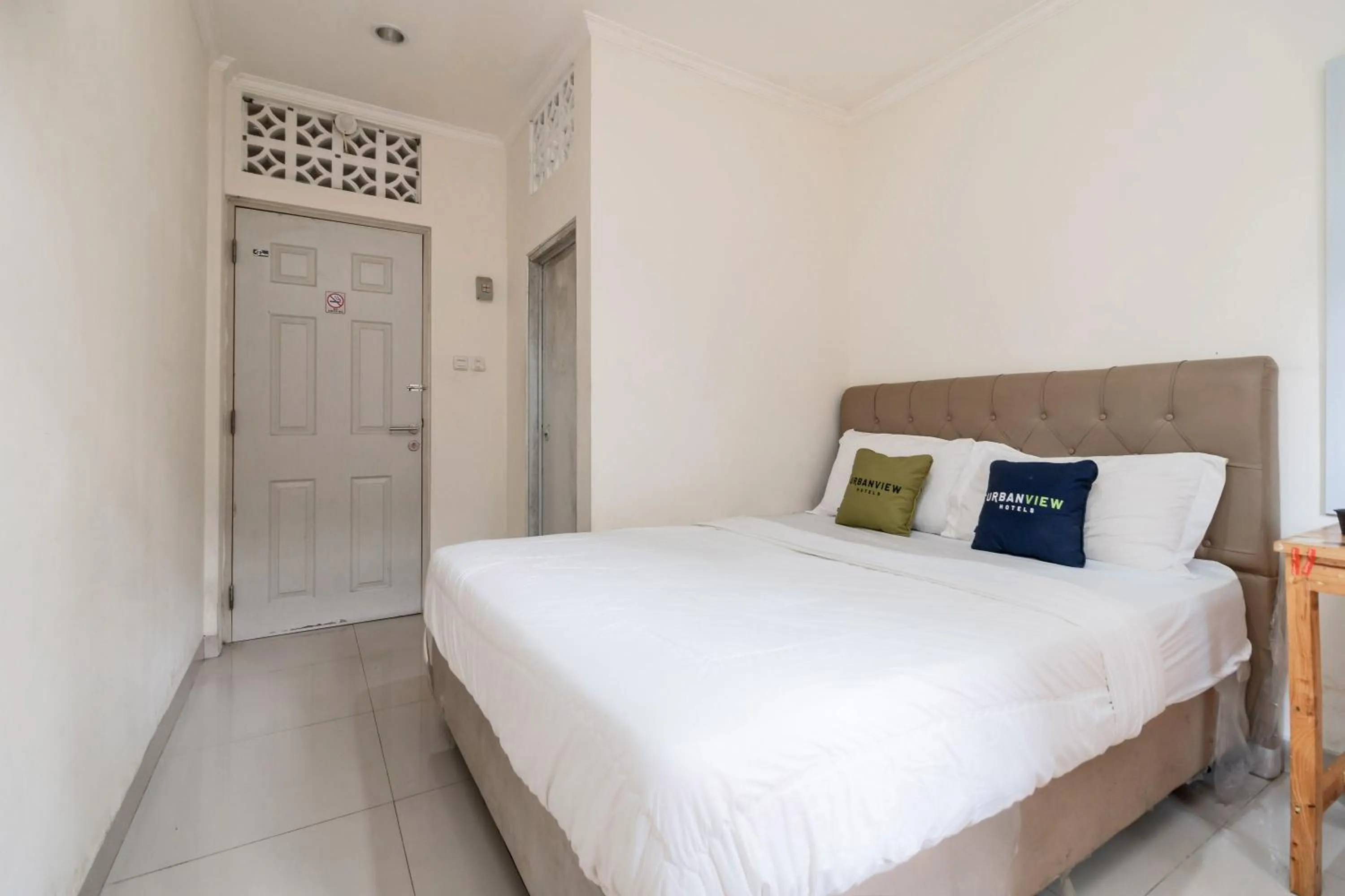 Bed in Urbanview Hotel Minongga Pondok Labu by RedDoorz