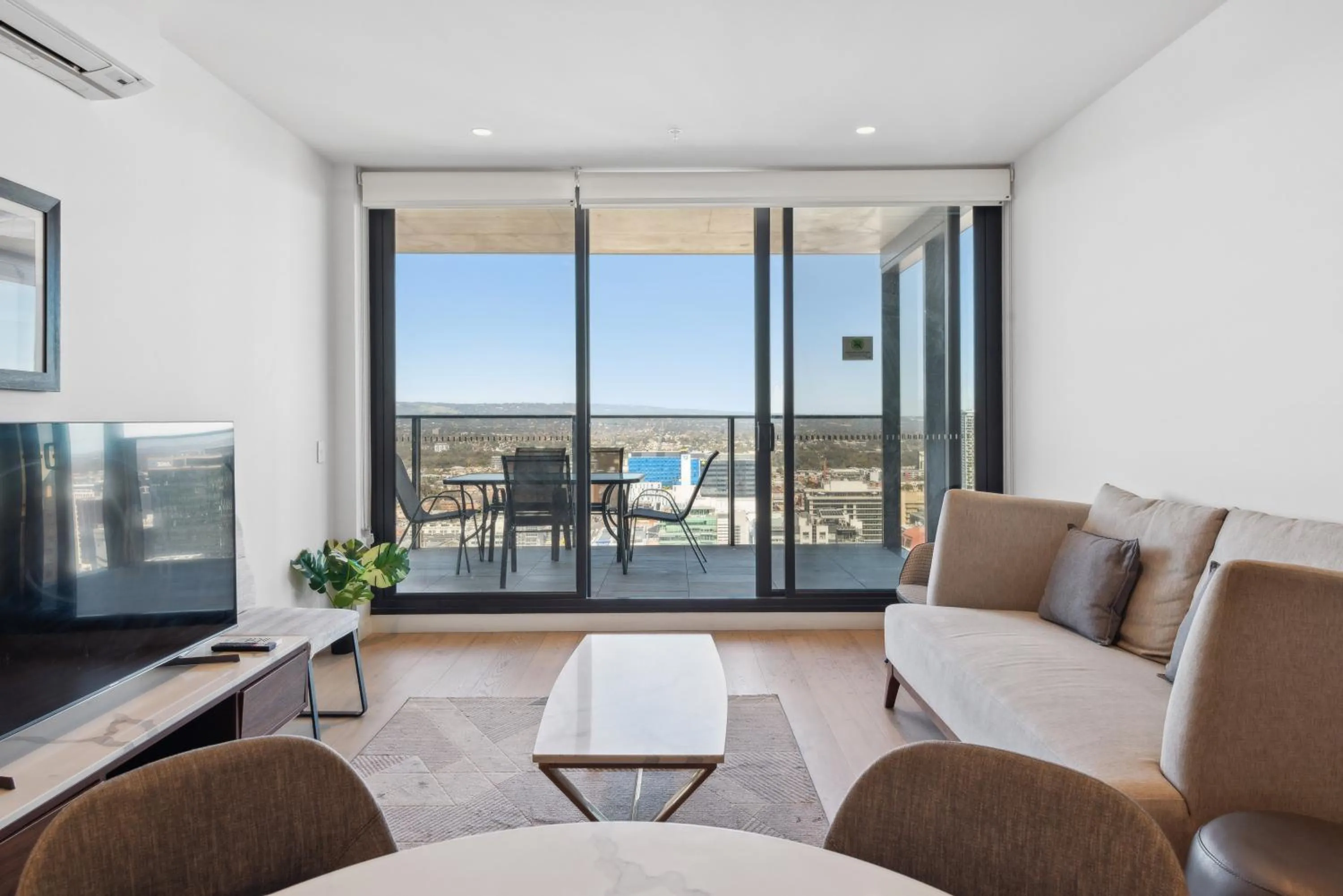 Living room in Realm Apartments by CLLIX