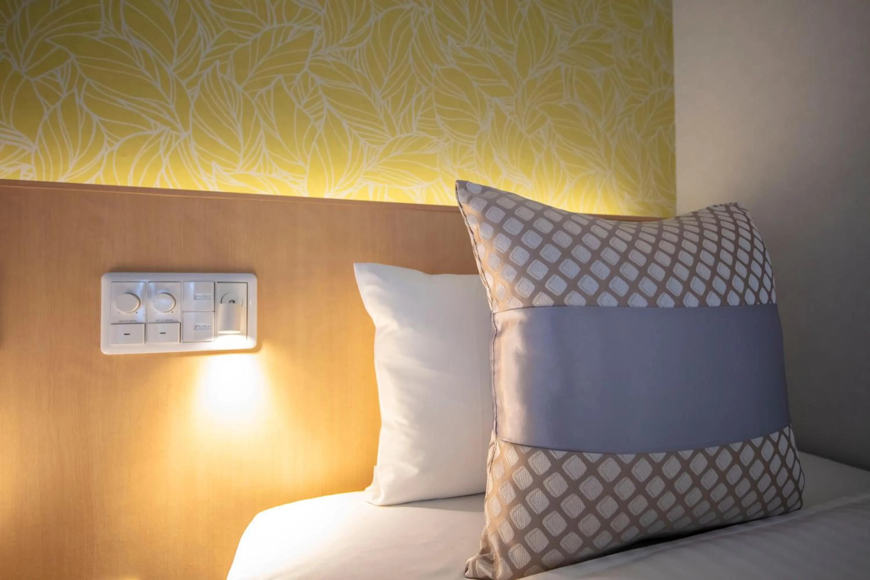 Bed in GRAND BASE Okayama Ekimae