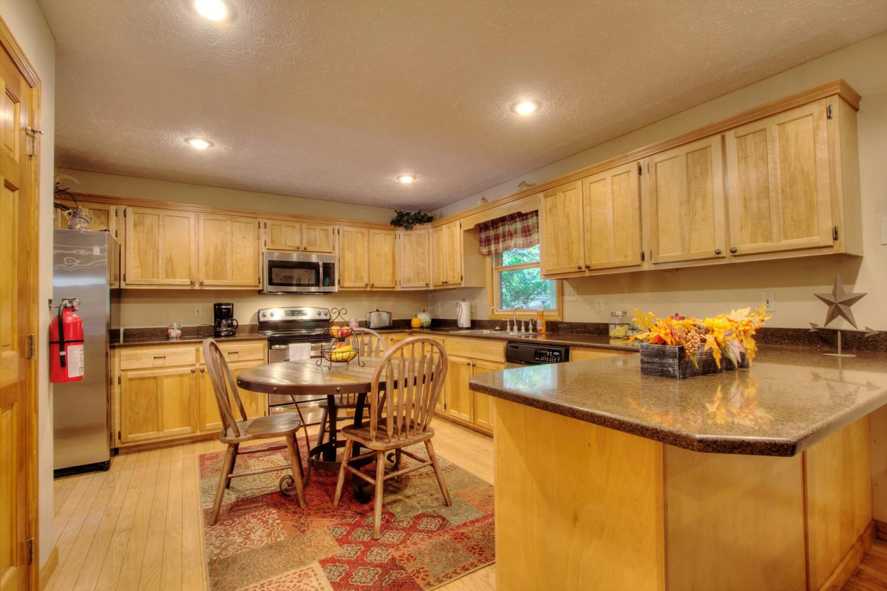 Kitchen or kitchenette in Gorgeous "Country Roads" by HoneyBearCabins 4BR 4BA, next to pool, easy drive, main strip location!