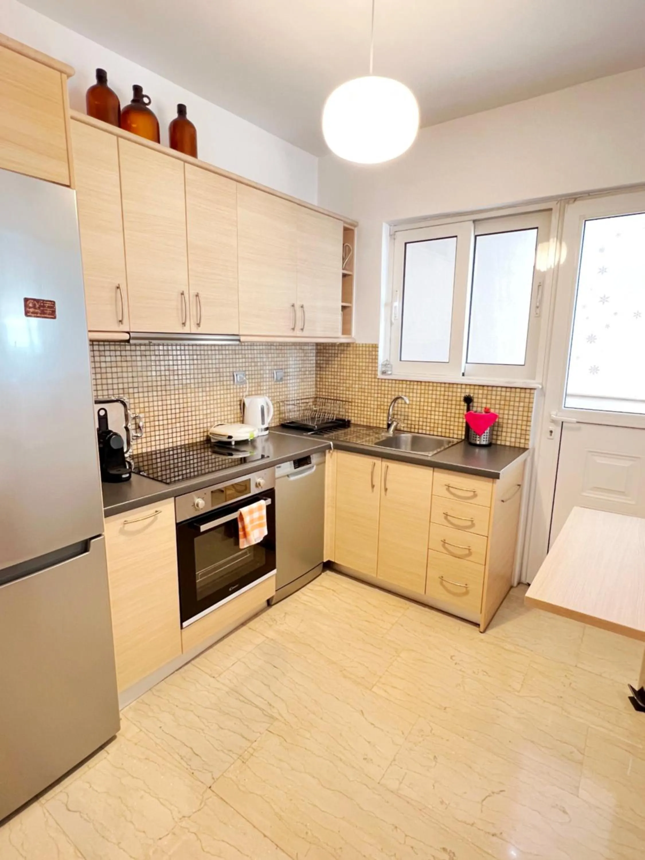 Kitchen or kitchenette in Peaceful Apartment by Flisvos Marina by Athenian Homes