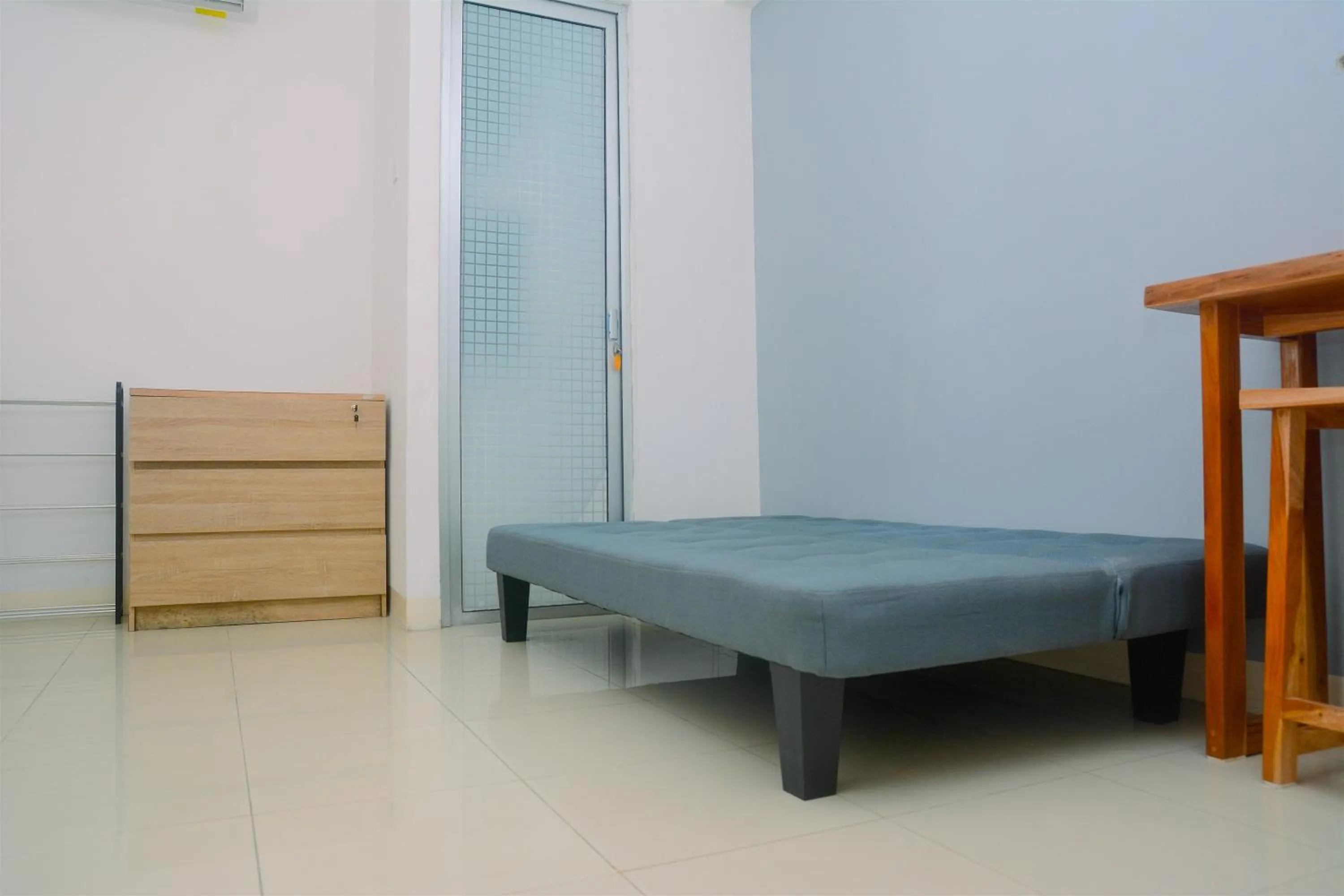 Living room, Bed in Best Deal 3BR Apartment Bassura City near Shopping Center By Travelio