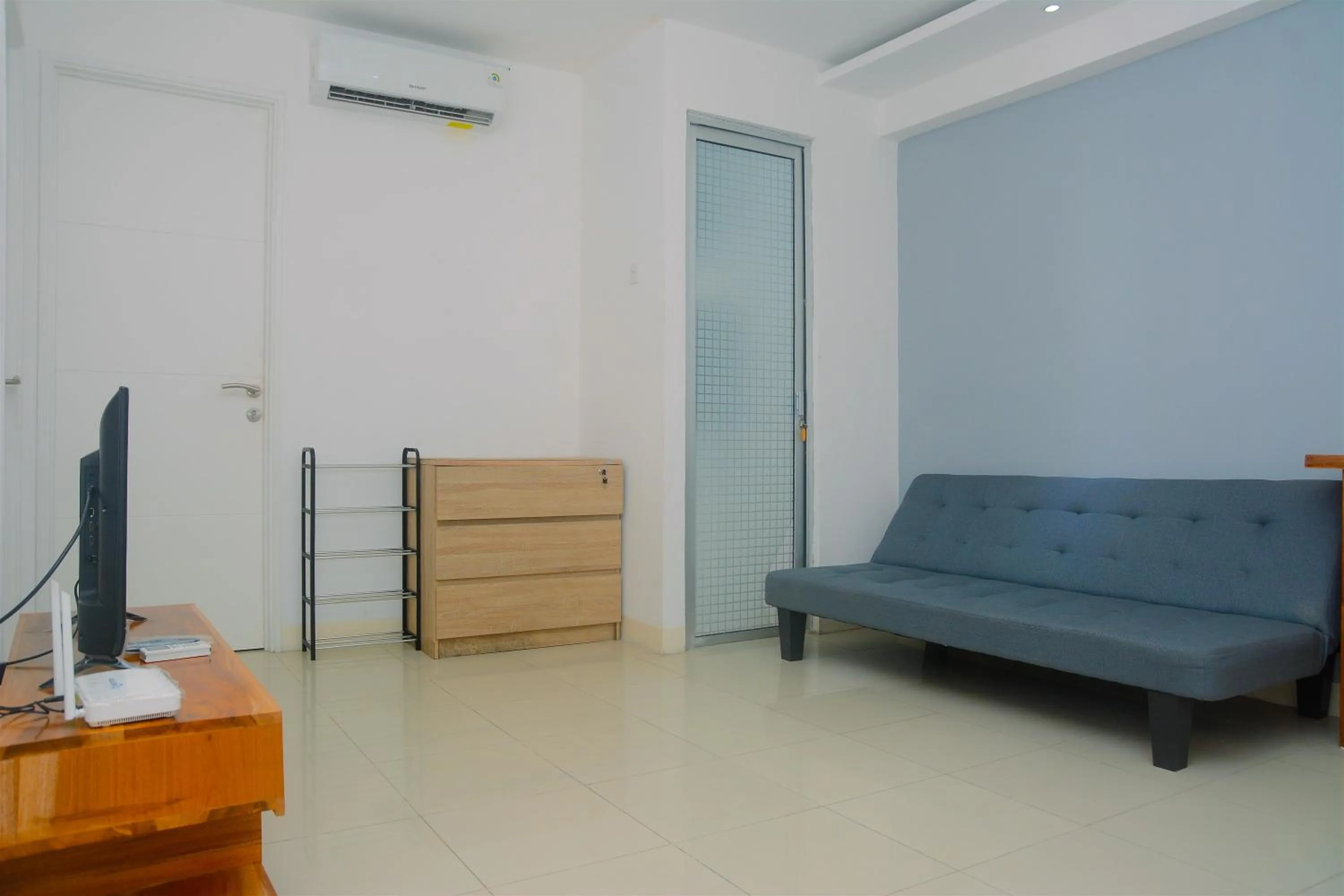 Living room in Best Deal 3BR Apartment Bassura City near Shopping Center By Travelio