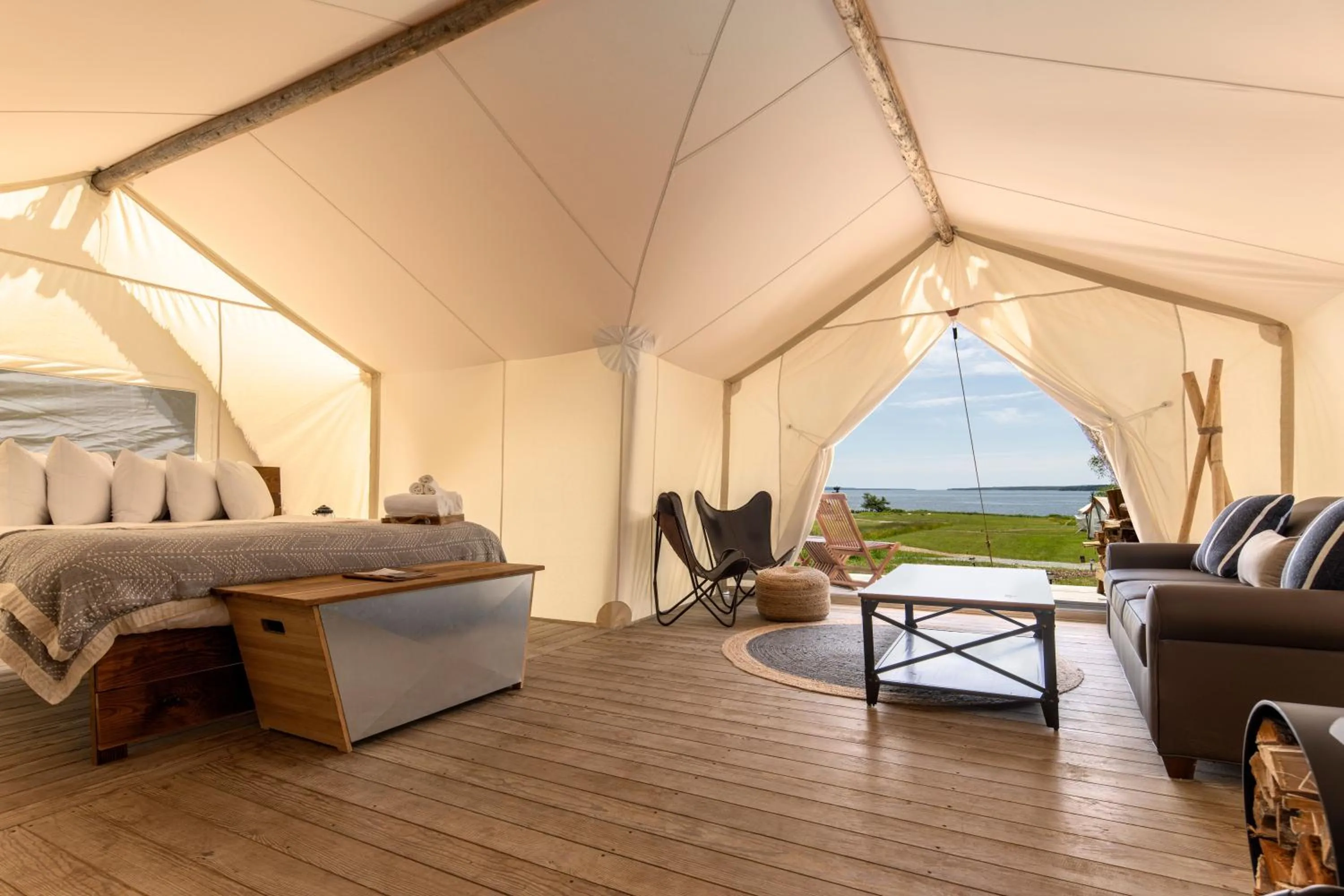 Seating area, Bed in Under Canvas Acadia