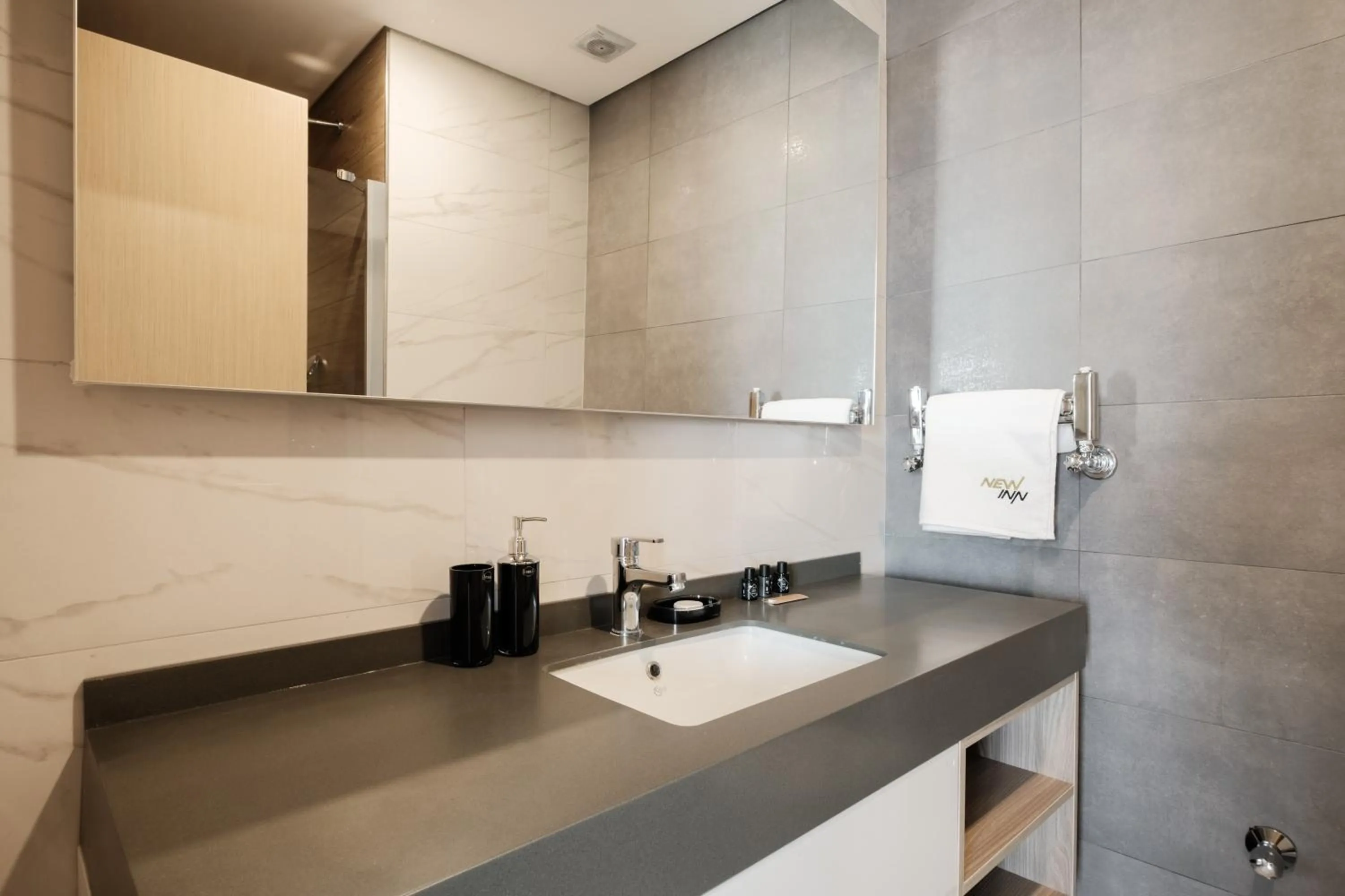 Bathroom in Grand Residence by NewInn