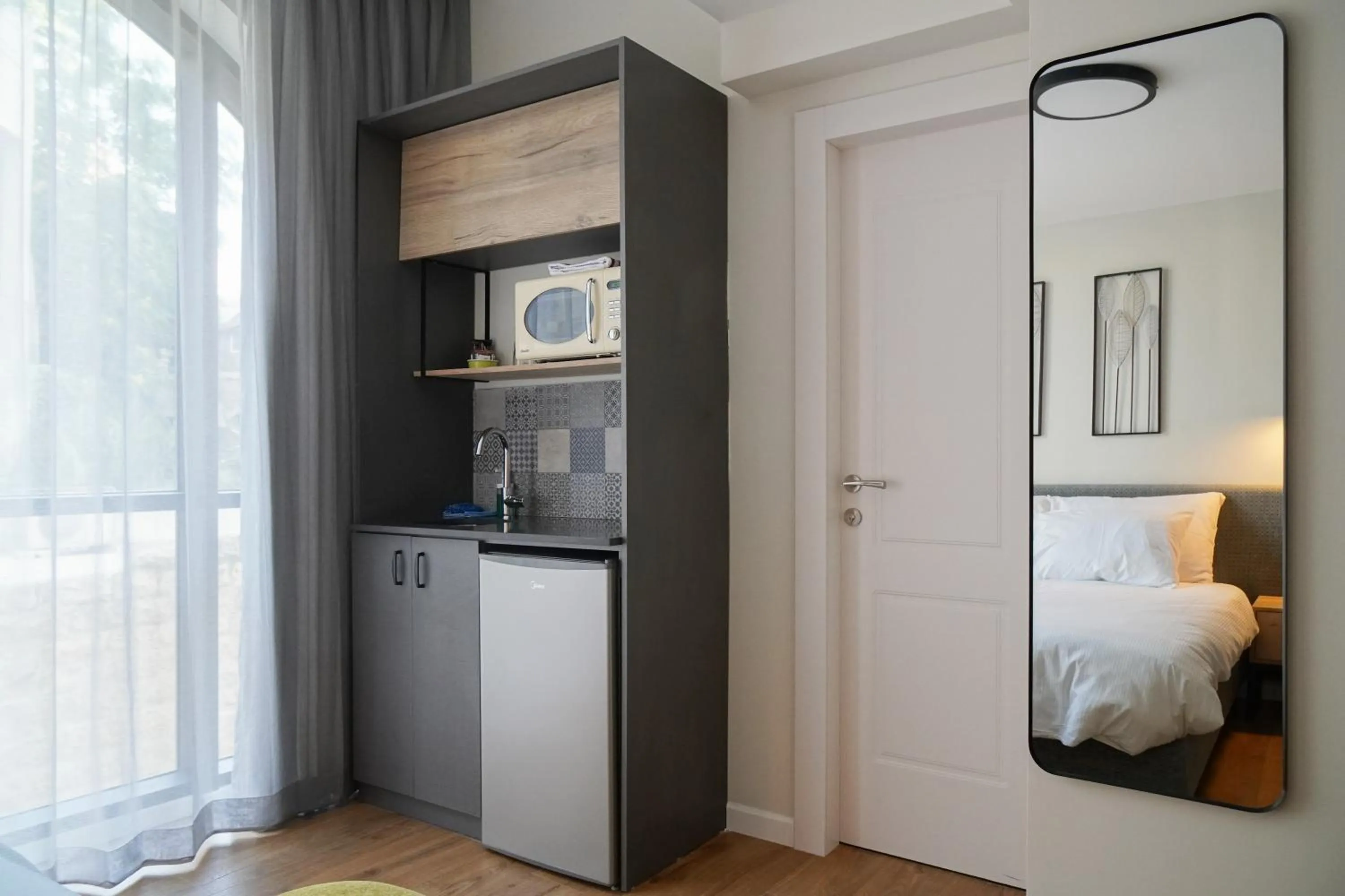 Kitchen or kitchenette, Bed in Apartique Hotel