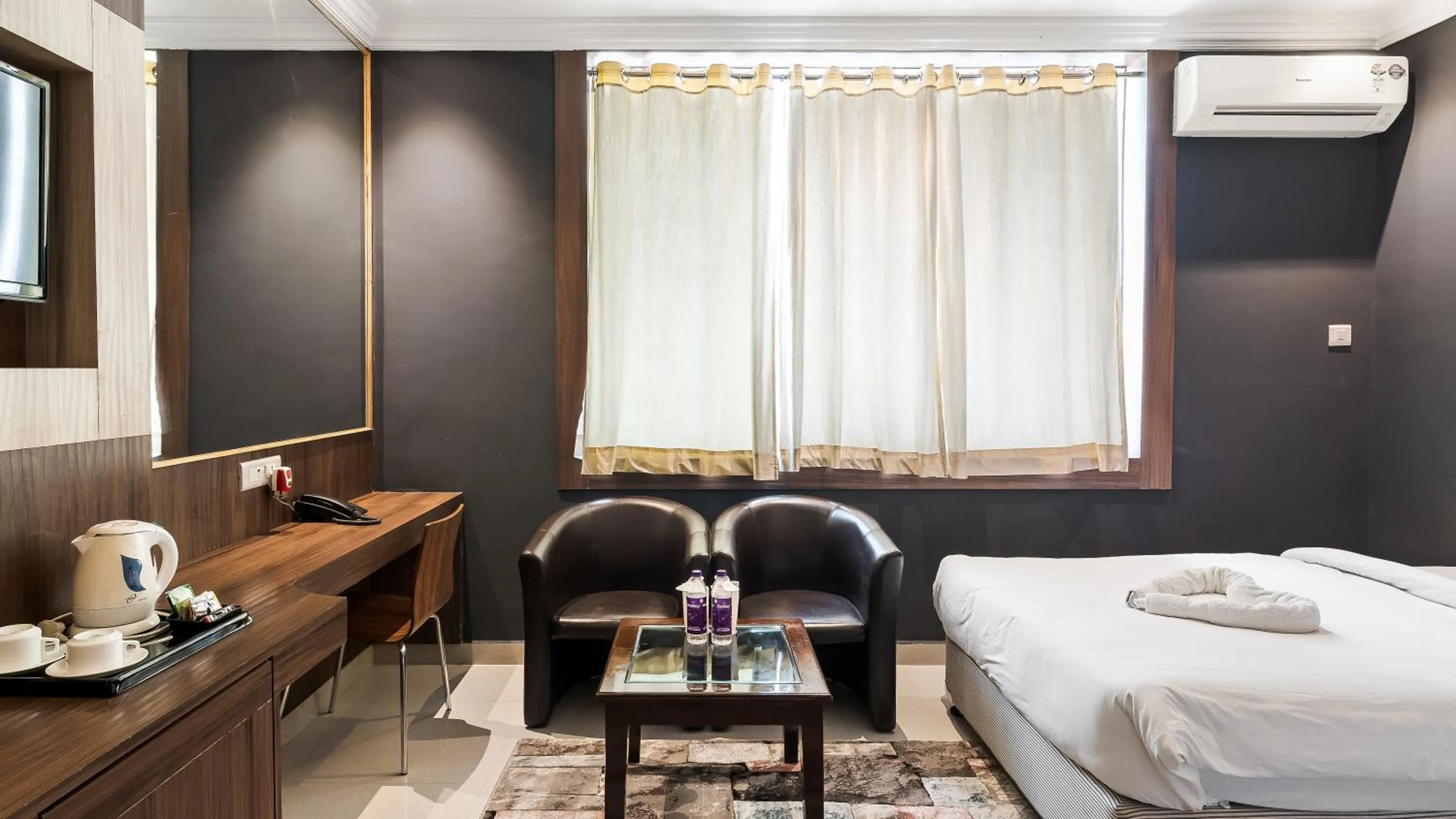 Seating area, Bed in Niranjana Hotel Bodhgaya