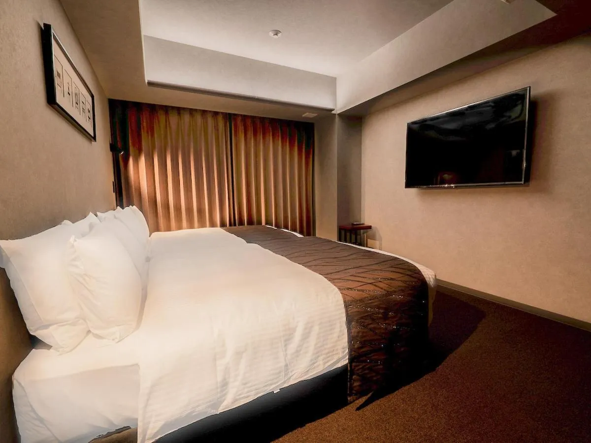 Bed in Randor Hotel Namba Osaka Suites