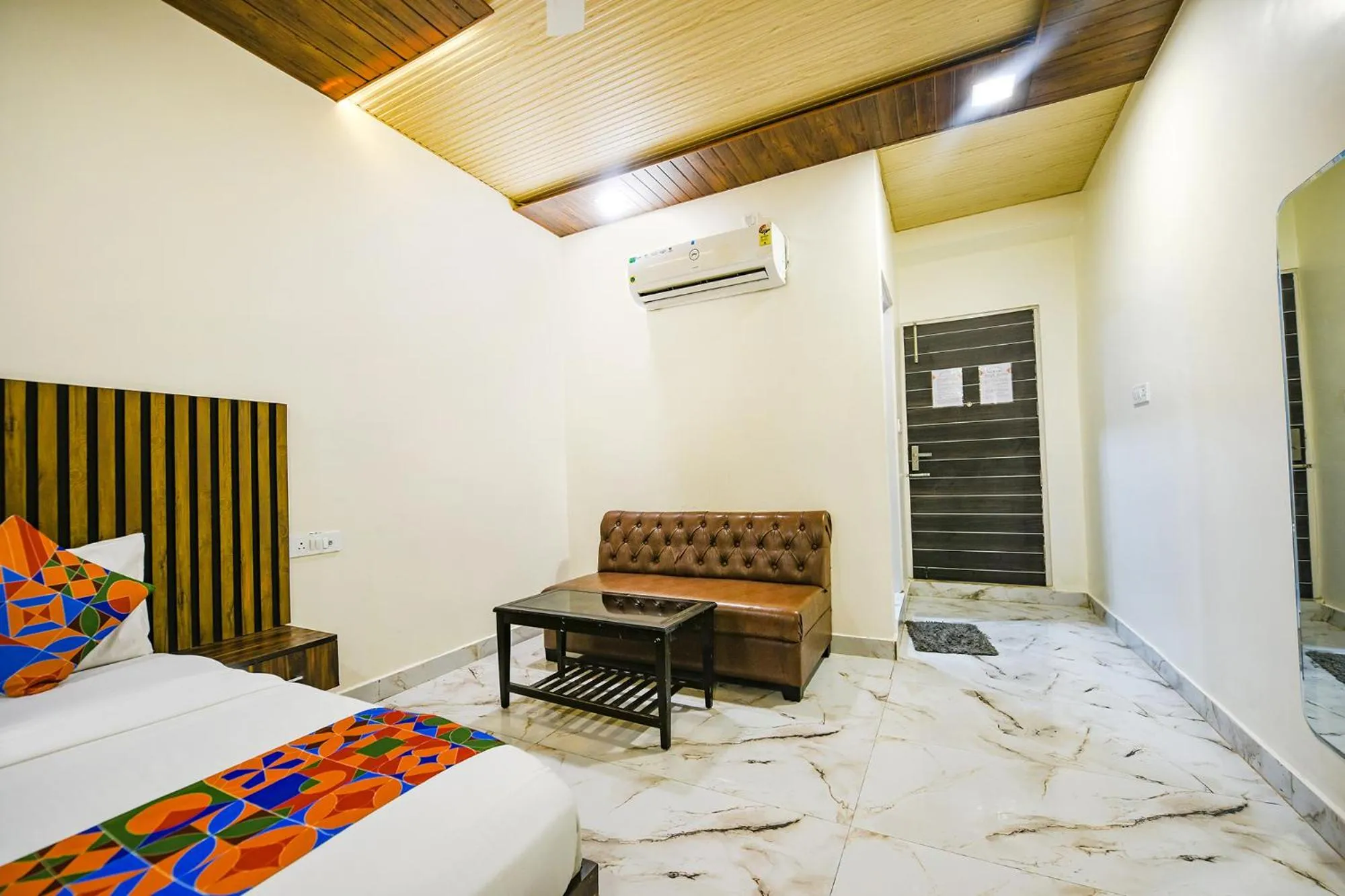 Seating area, Bed in FabHotel The Crystal Palace Rohini