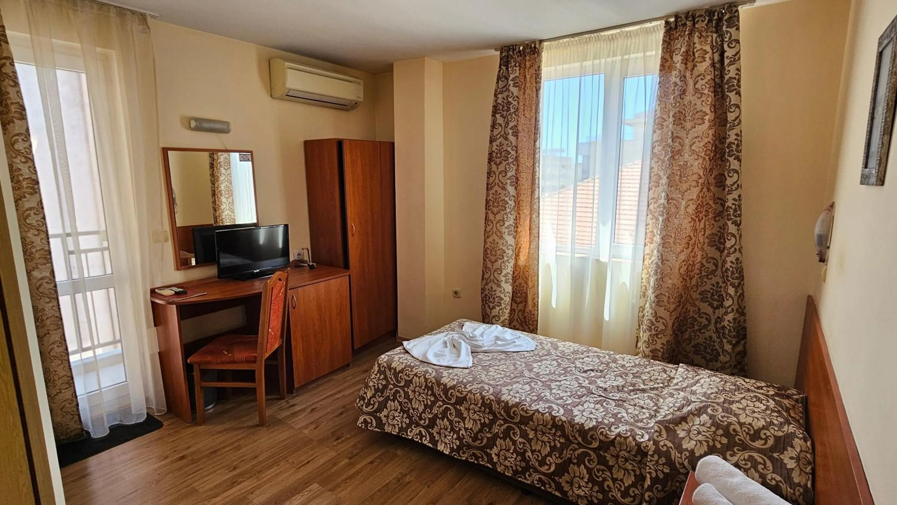 Bed in Caprice Family Hotel