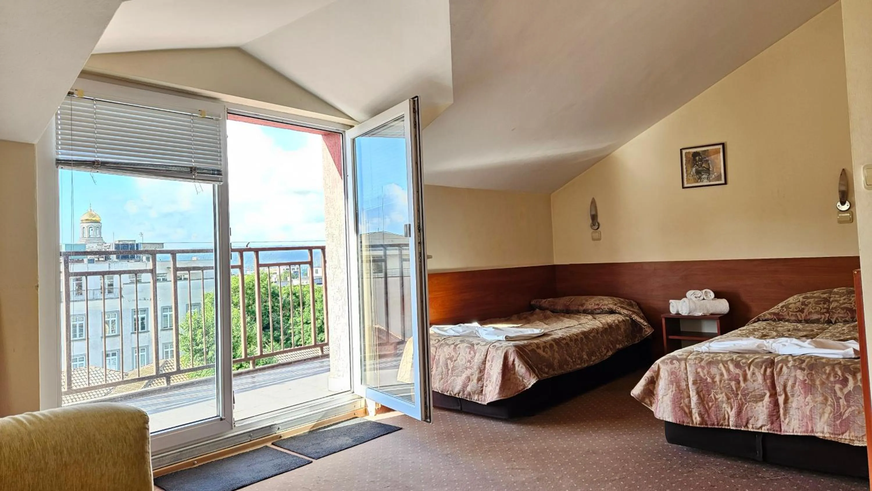 Bed in Caprice Family Hotel