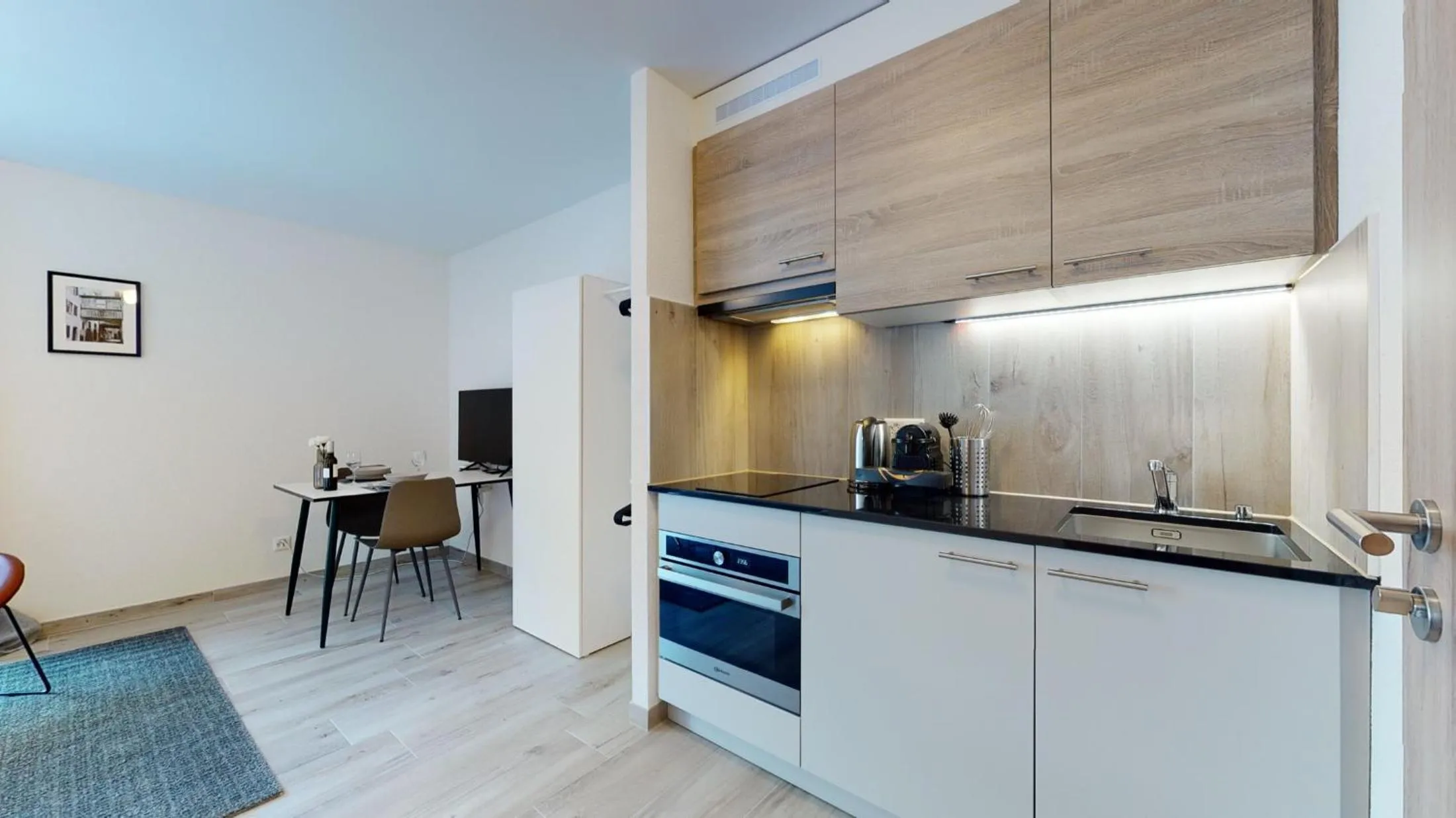 Kitchen or kitchenette in Nonanteneuf appart hōtel Aigle - contactless check-in