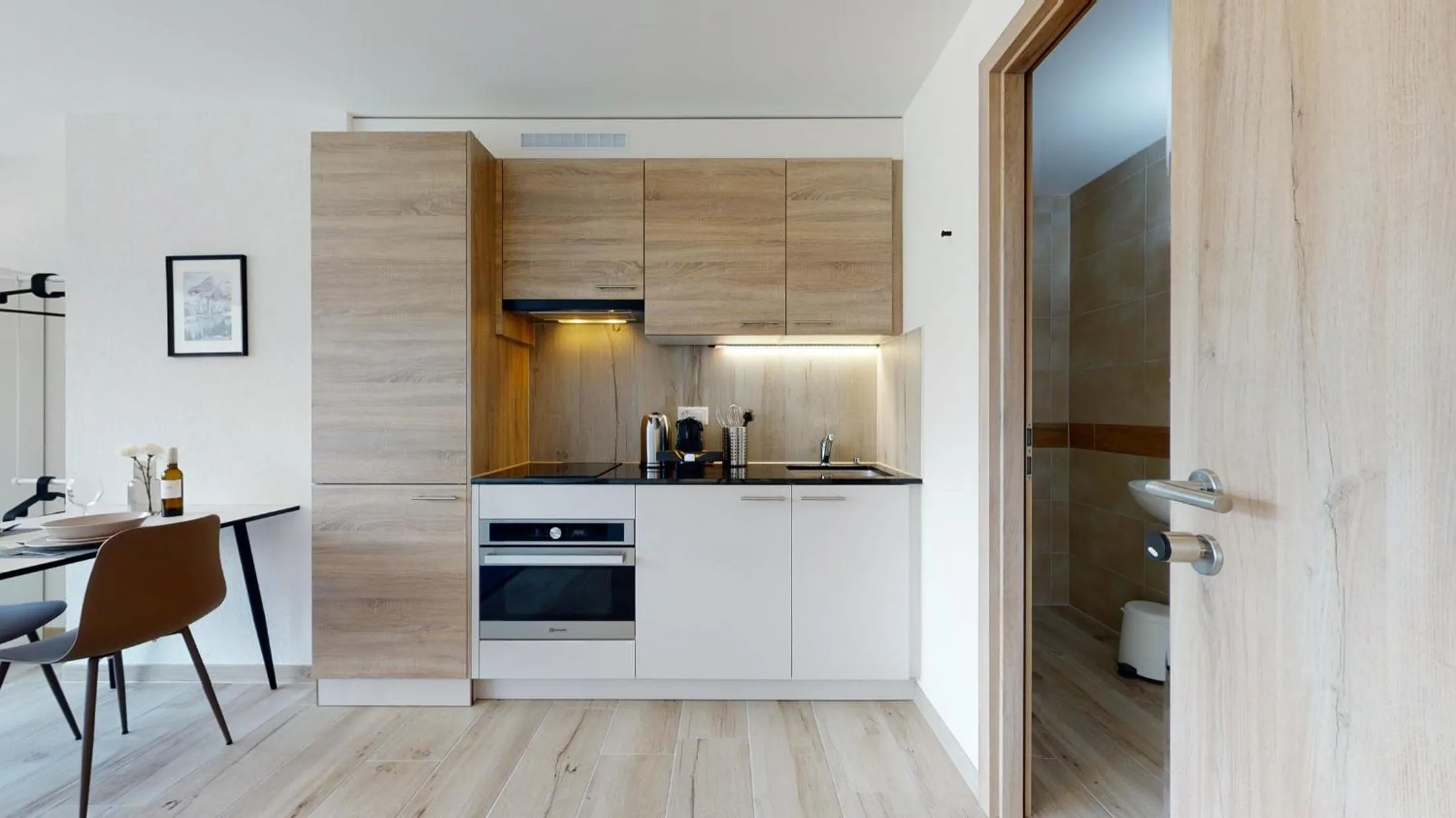 Kitchen or kitchenette in Nonanteneuf appart hōtel Aigle - contactless check-in