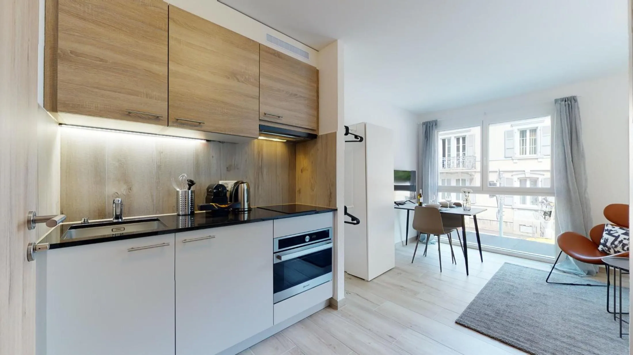 Kitchen or kitchenette in Nonanteneuf appart hōtel Aigle - contactless check-in