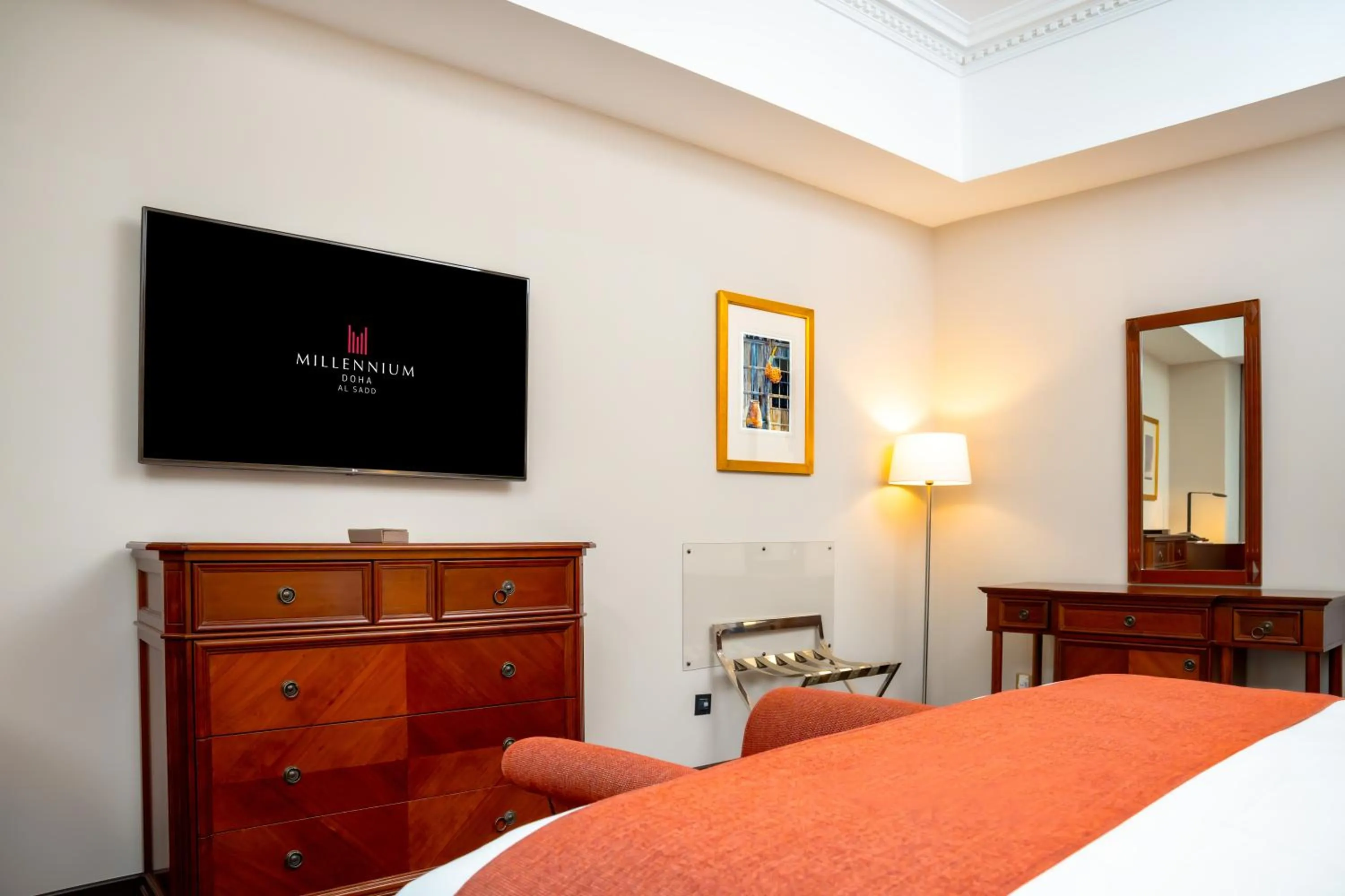 Communal lounge/ TV room, Bed in Millennium Hotel Doha