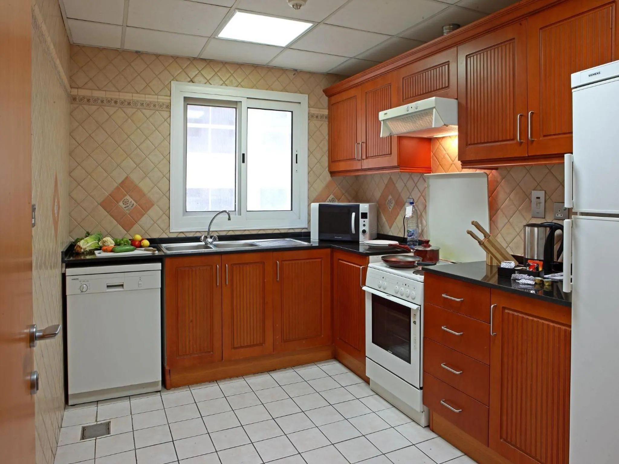 Kitchen or kitchenette in Rose Garden Hotel Apartments - Bur Dubai