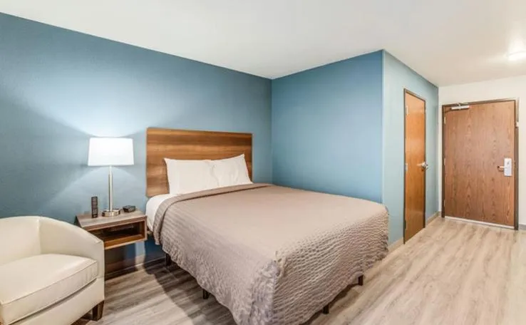 Bed in WoodSpring Suites Novi Farmington