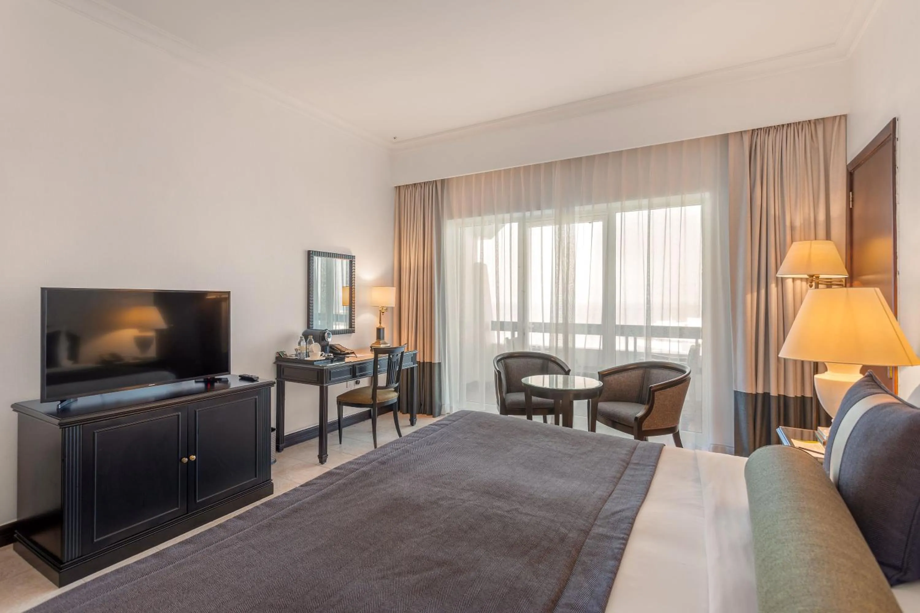 Communal lounge/ TV room, Bed in Ajman Hotel & Villas by Blazon Hotels