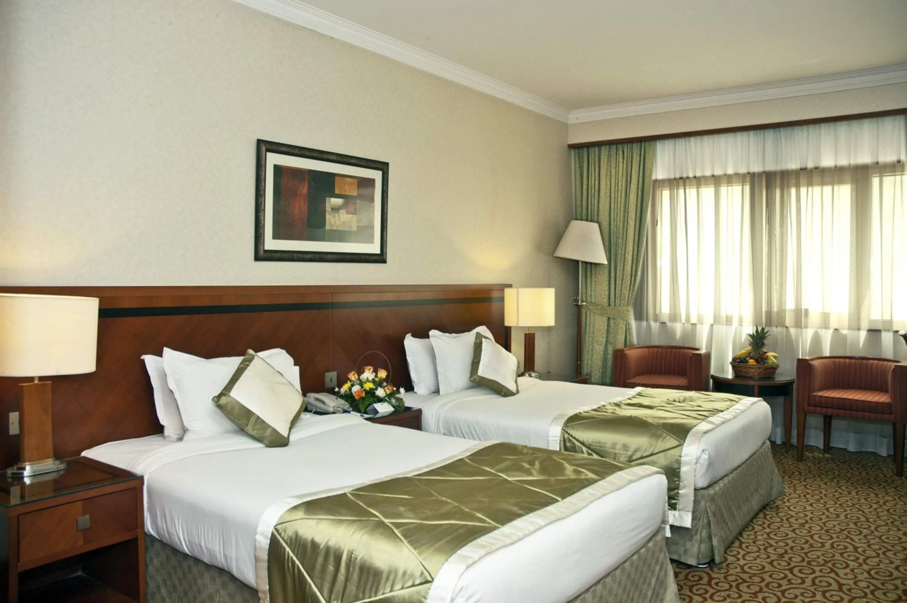Bed in Ramee Royal Hotel