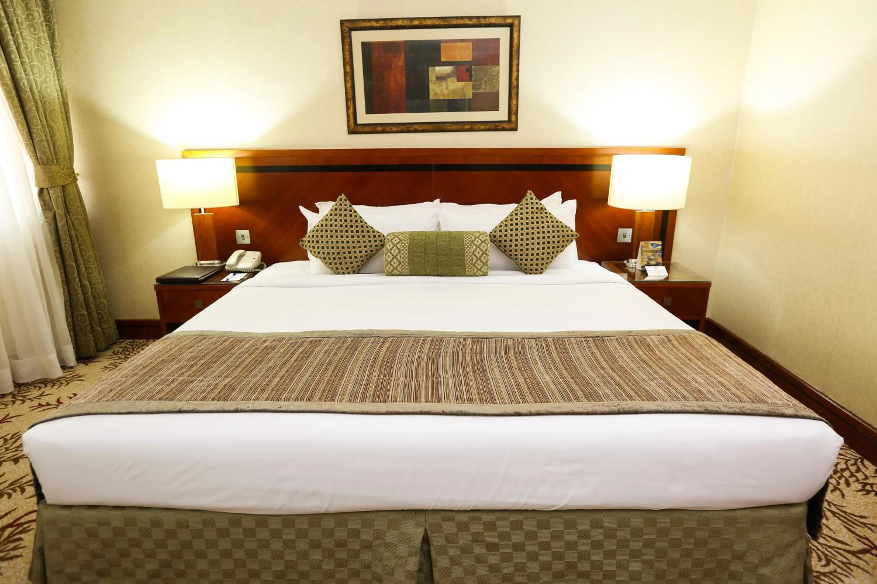 Bed in Ramee Royal Hotel