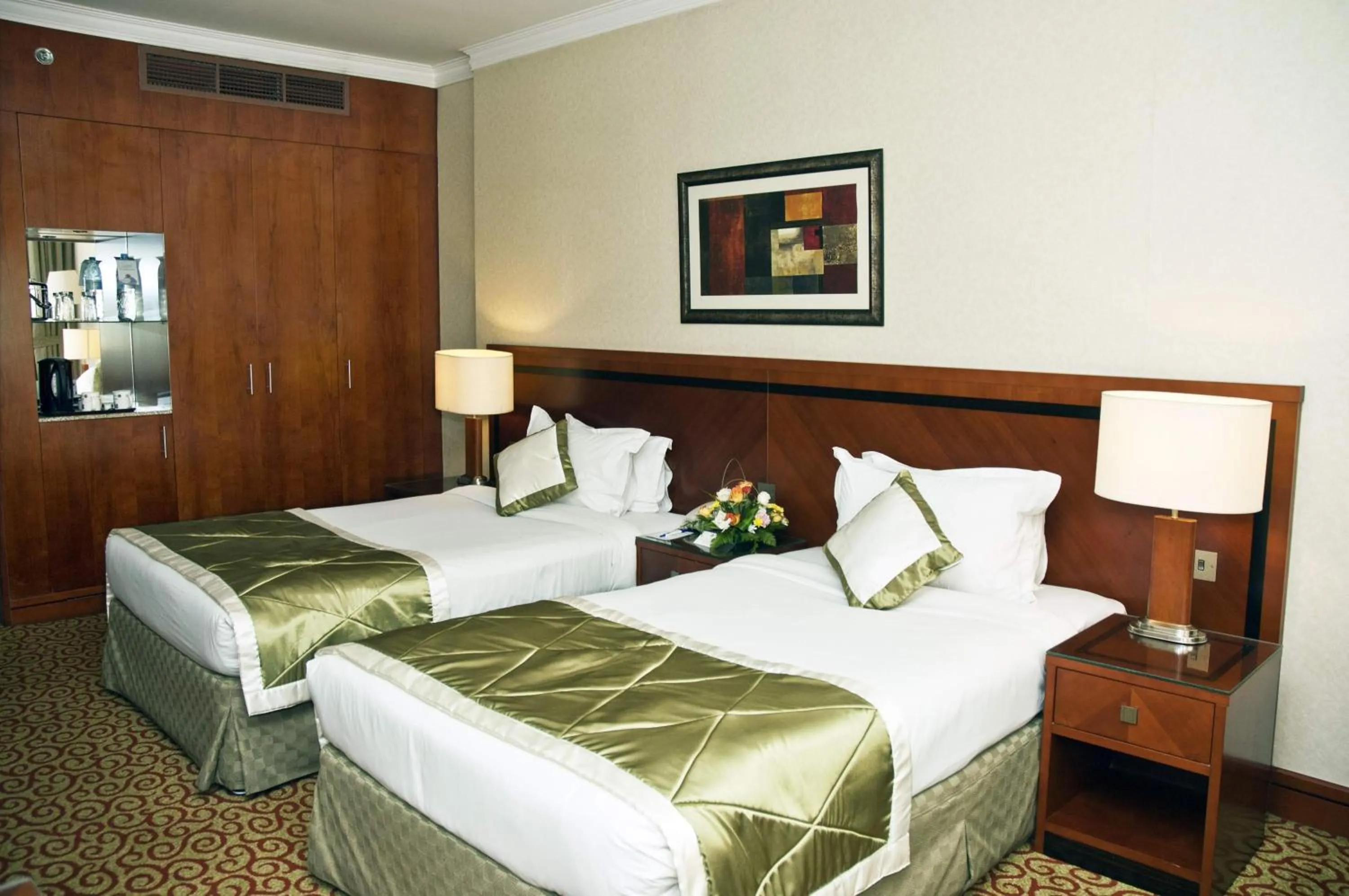 Bed in Ramee Royal Hotel