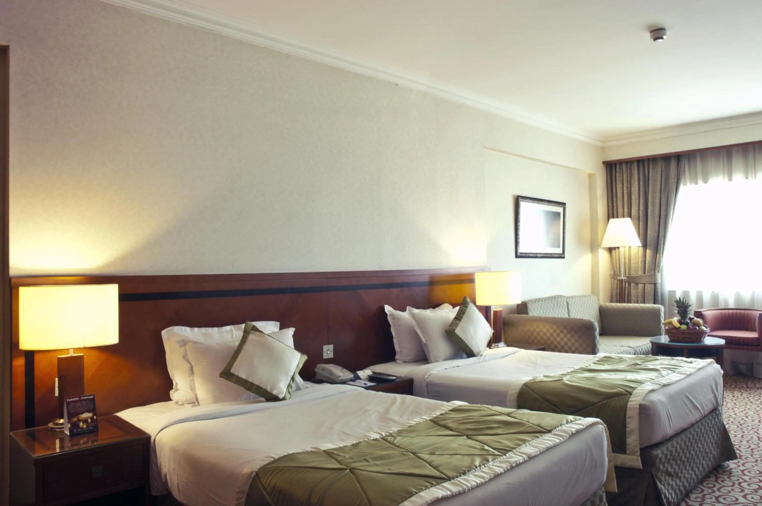 Bed in Ramee Royal Hotel