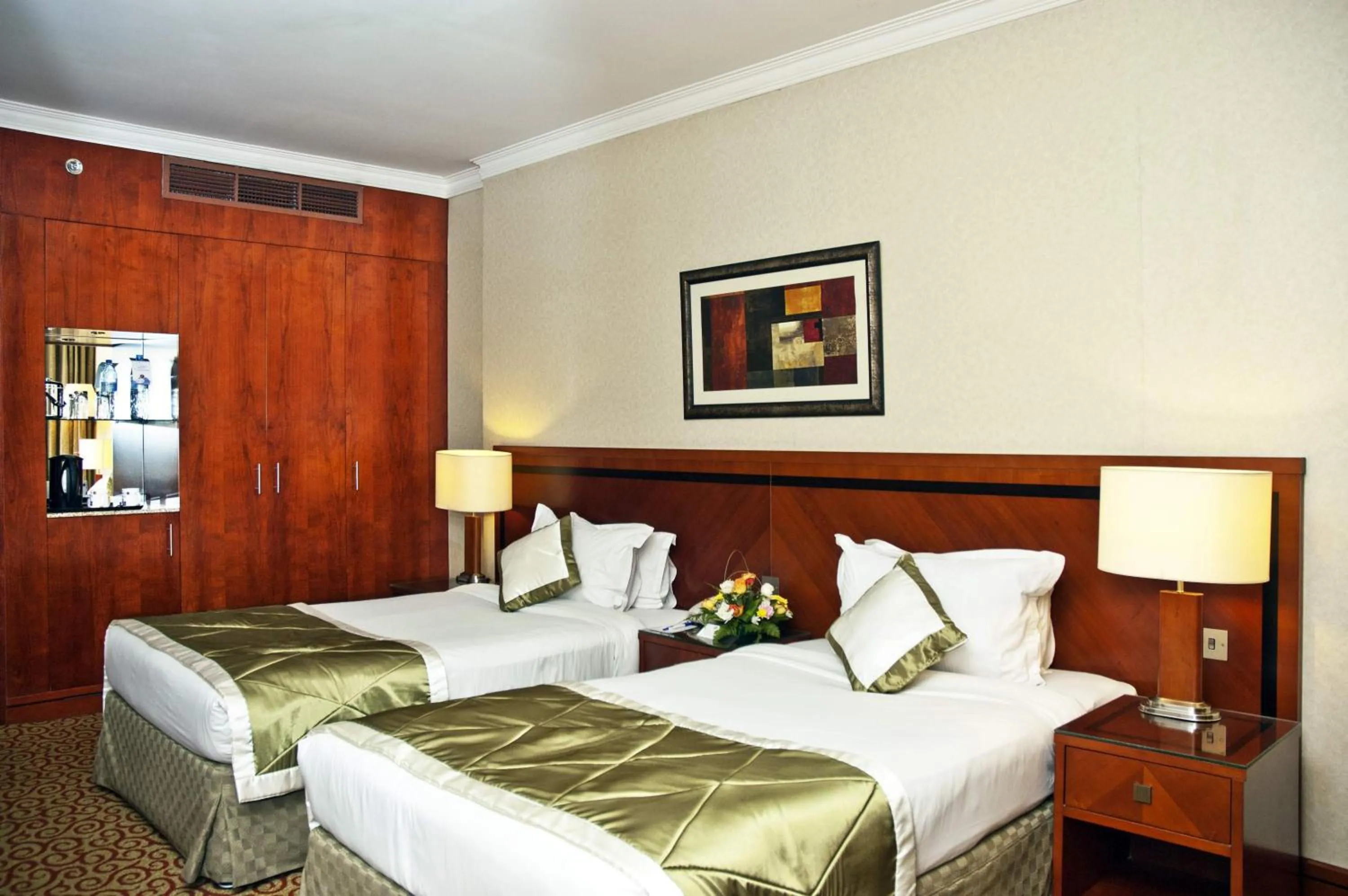 Bed in Ramee Royal Hotel