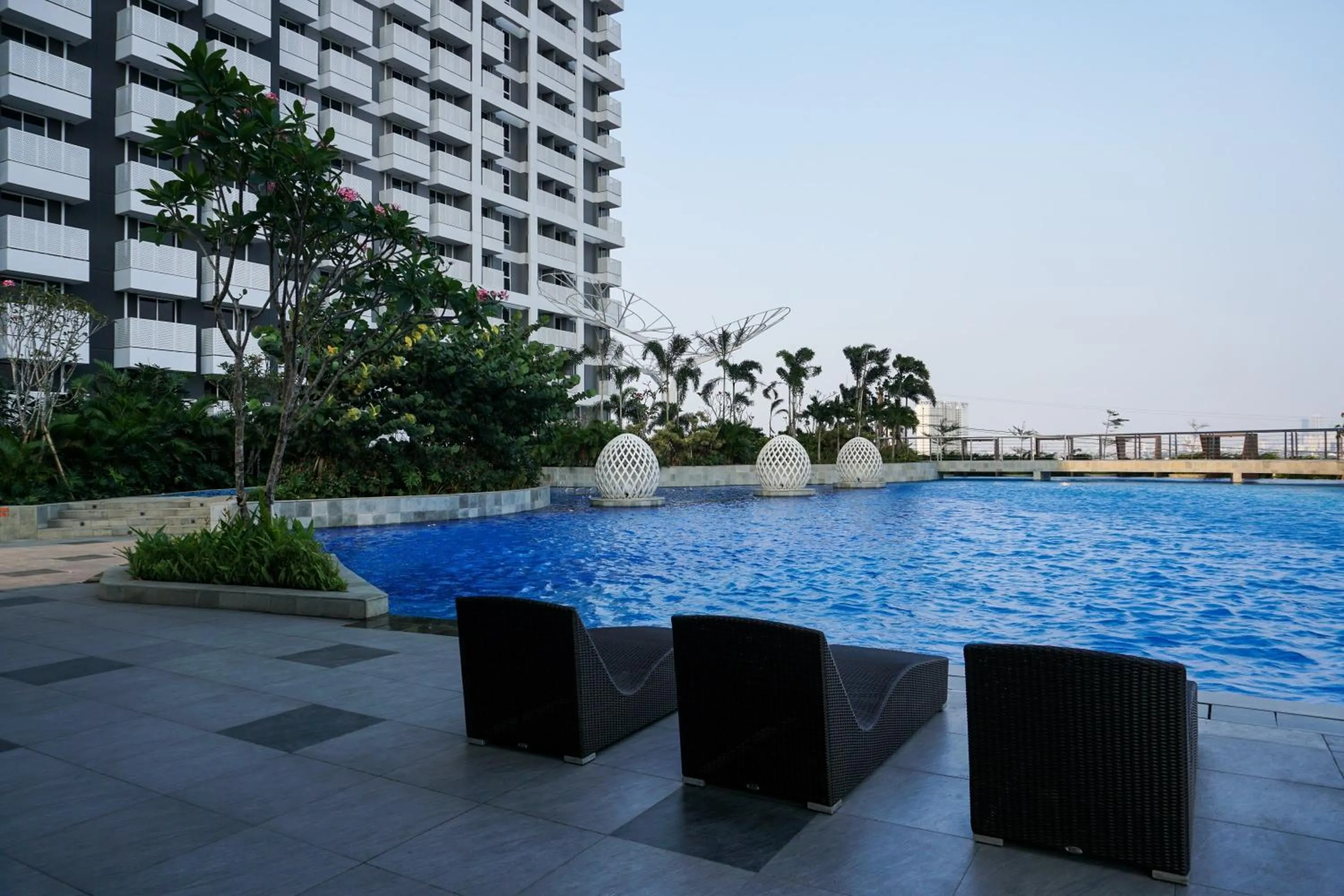 Property building in Relax and Comfy with Pool View at Studio West Vista Apartment By Travelio