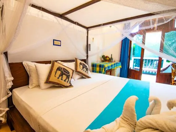 Bed in Frangipani Beach Villa