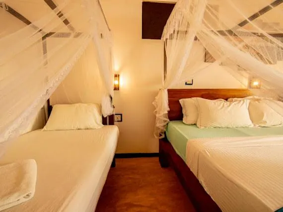 Bed in Frangipani Beach Villa